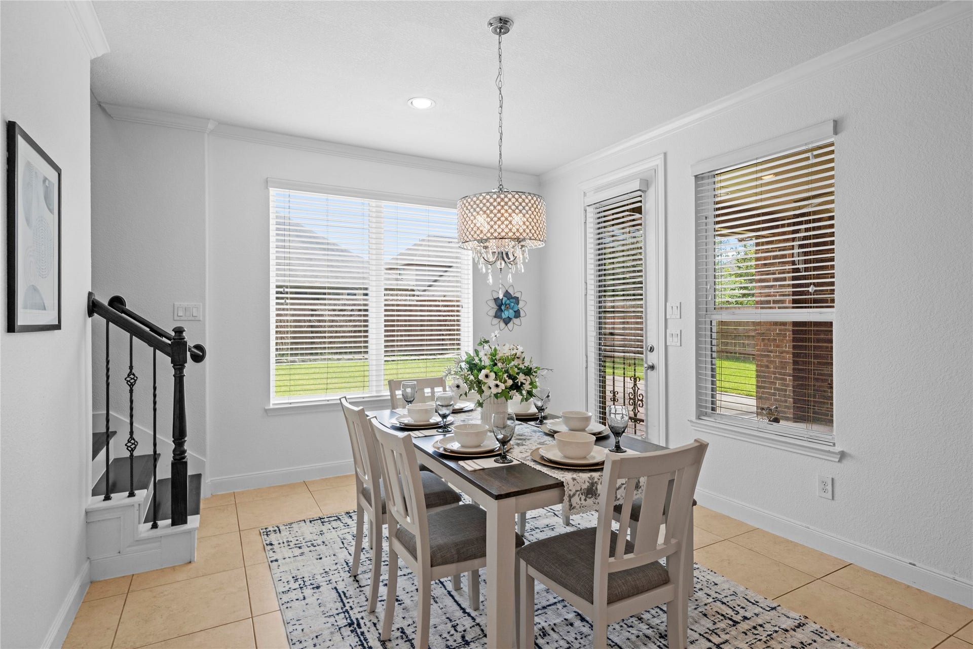 17315 Tomintoul Path, Richmond, TX 77407 An elegant breakfast nook area showcases a coffered ceiling, graceful chandelier, abundant natural light, and seamless access to the adjoining kitchen.