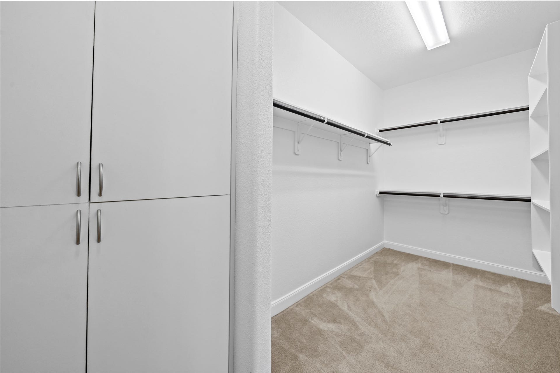 17315 Tomintoul Path, Richmond, TX 77407 A spacious walk-in closet delivers exceptional organization with built-in cabinetry, abundant hanging space, integrated shelving, and a thoughtfully designed layout.