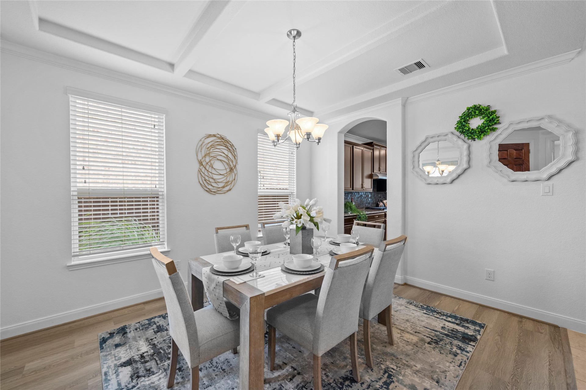 17315 Tomintoul Path, Richmond, TX 77407 A gracious dining space pairs architectural ceiling detail with soft natural illumination and an inviting layout designed for memorable gatherings.