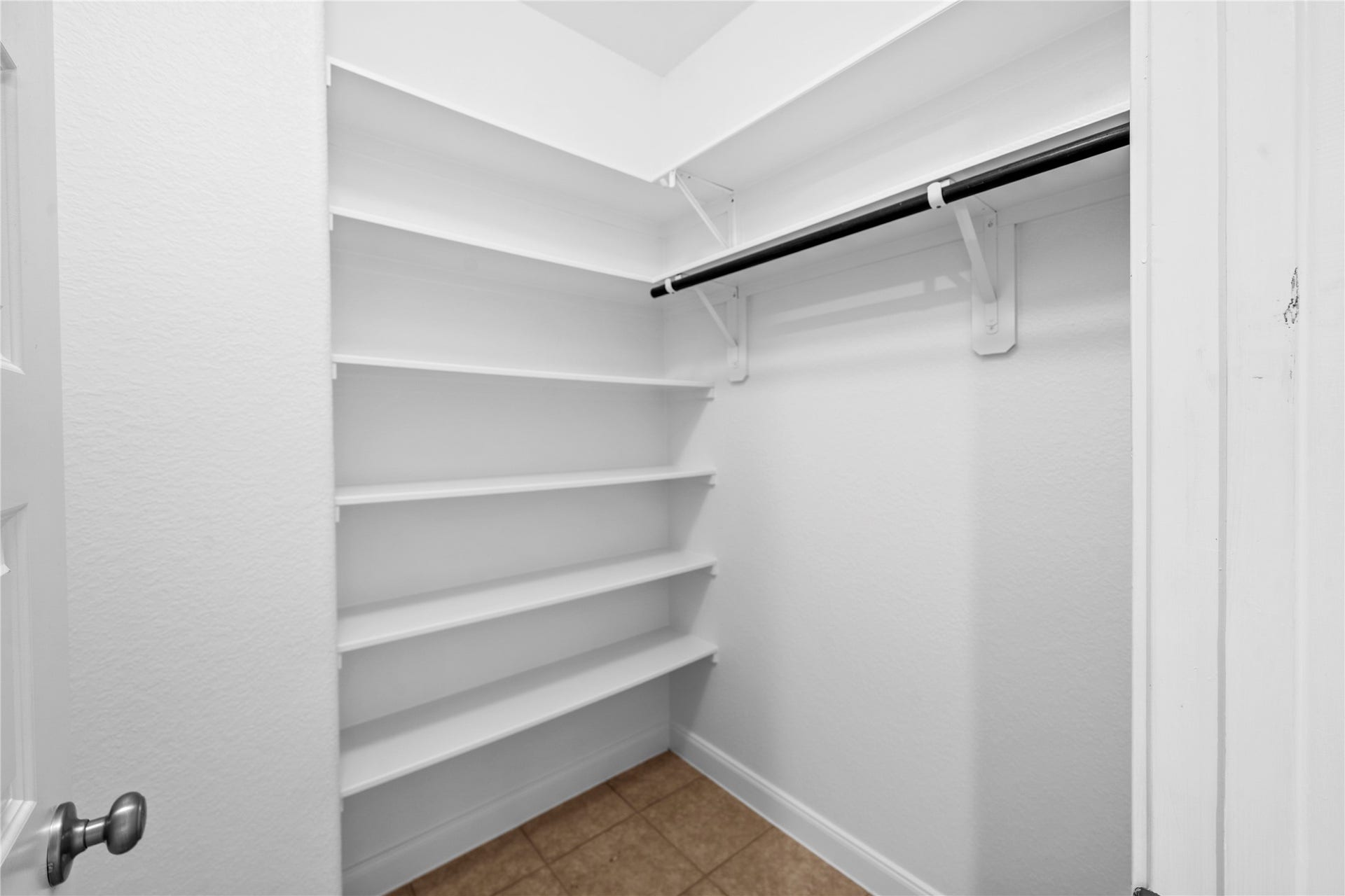 17315 Tomintoul Path, Richmond, TX 77407 Well-organized second closet offers extensive built-in shelving and dedicated hanging space for streamlined, everyday storage.