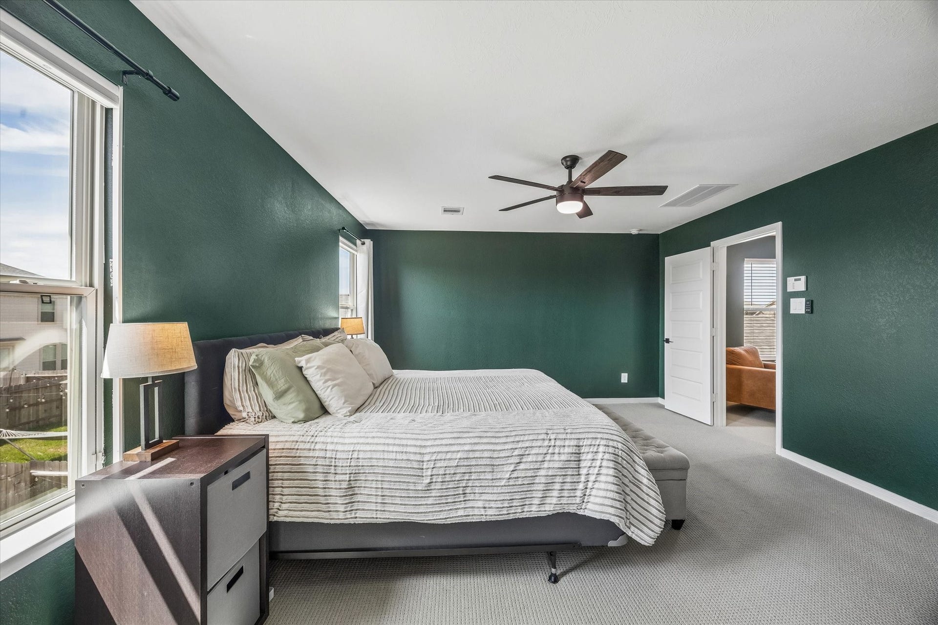 2852 Grand Anse Drive, Katy, TX 77493 Generously sized primary suite featuring windows, a ceiling fan, and plenty of space for a king-sized bed and additional furnishings.