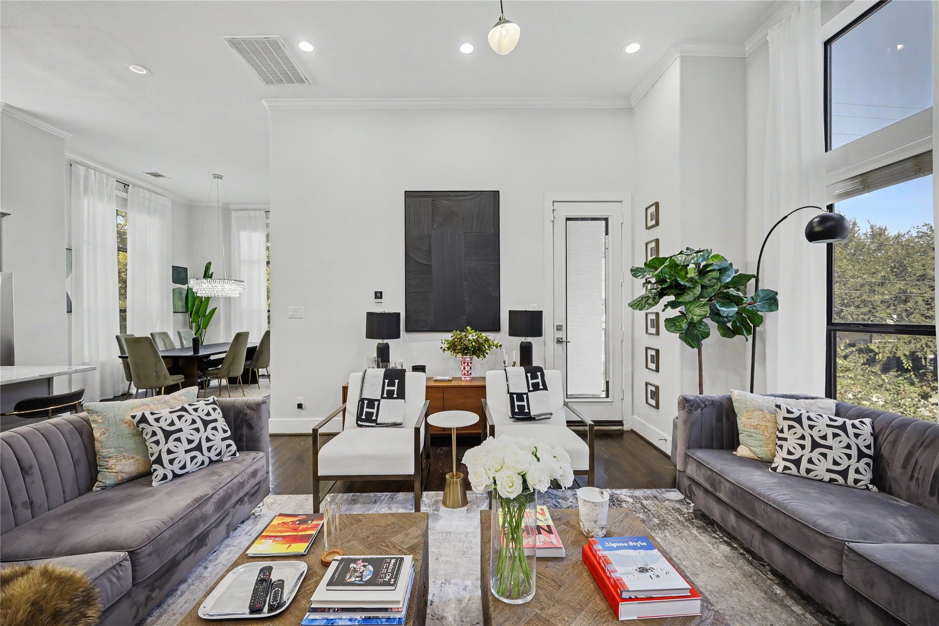 Living room includes 55" OLED TV that is wire-free and has Sonos speakers integrated into the ceiling and a subwoofer for surround sound. Sonos system can take adds to every room.