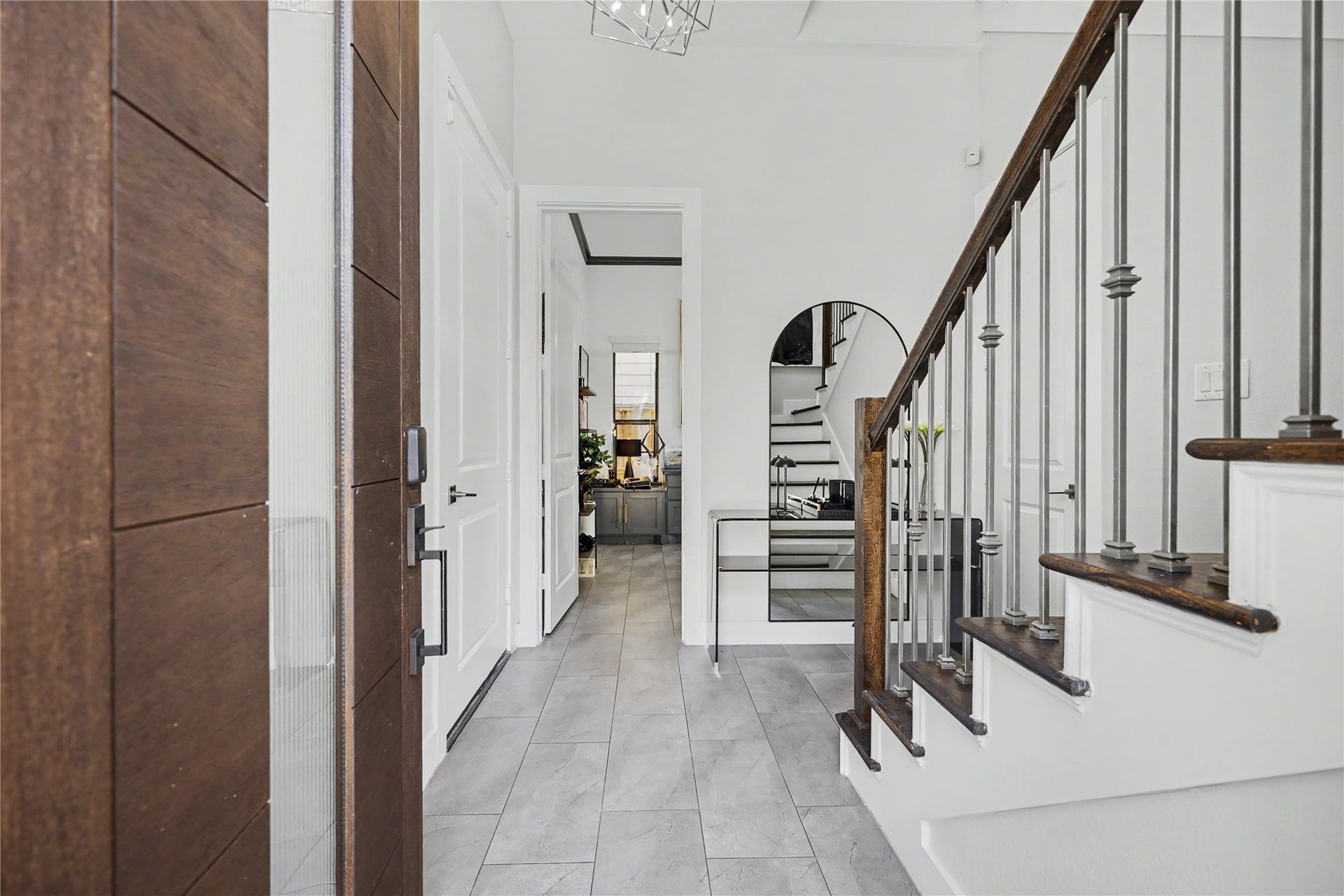 Welcome inside your new furnished home where custom tiles greet you. Door to the left leads to the garage. Bedroom straight ahead is currently a home office.