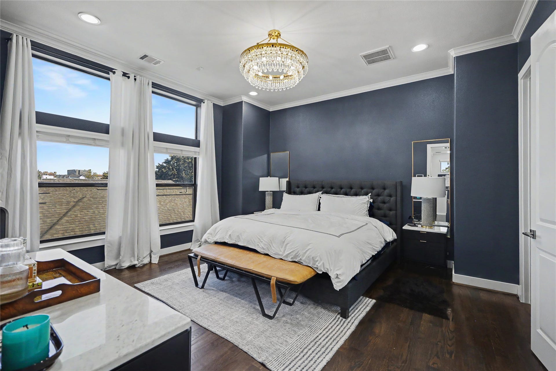 Welcome to the top floor and your primary bedroom sanctuary. Window treatments in addition to curtains in this bedroom.