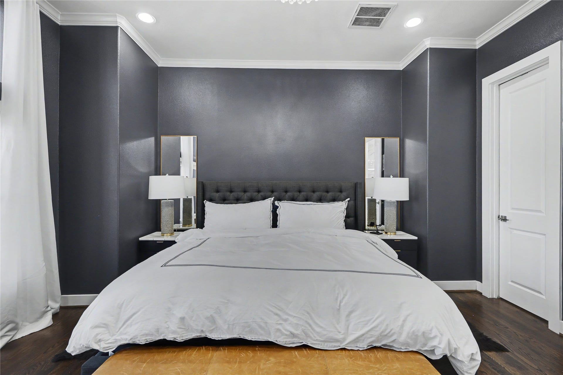 Rest and relaxation will be easy in this primary bedroom suite. Door to the right leads to the spa bath.