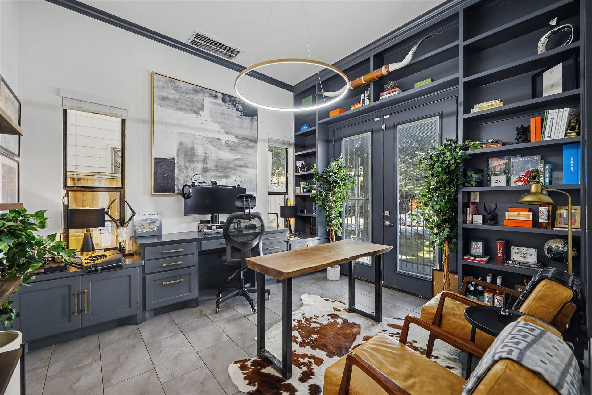 Custom built-in bookshelves and desk in this first-floor bedroom. This bedroom can still fit a bed to make it an actual bedroom as well.