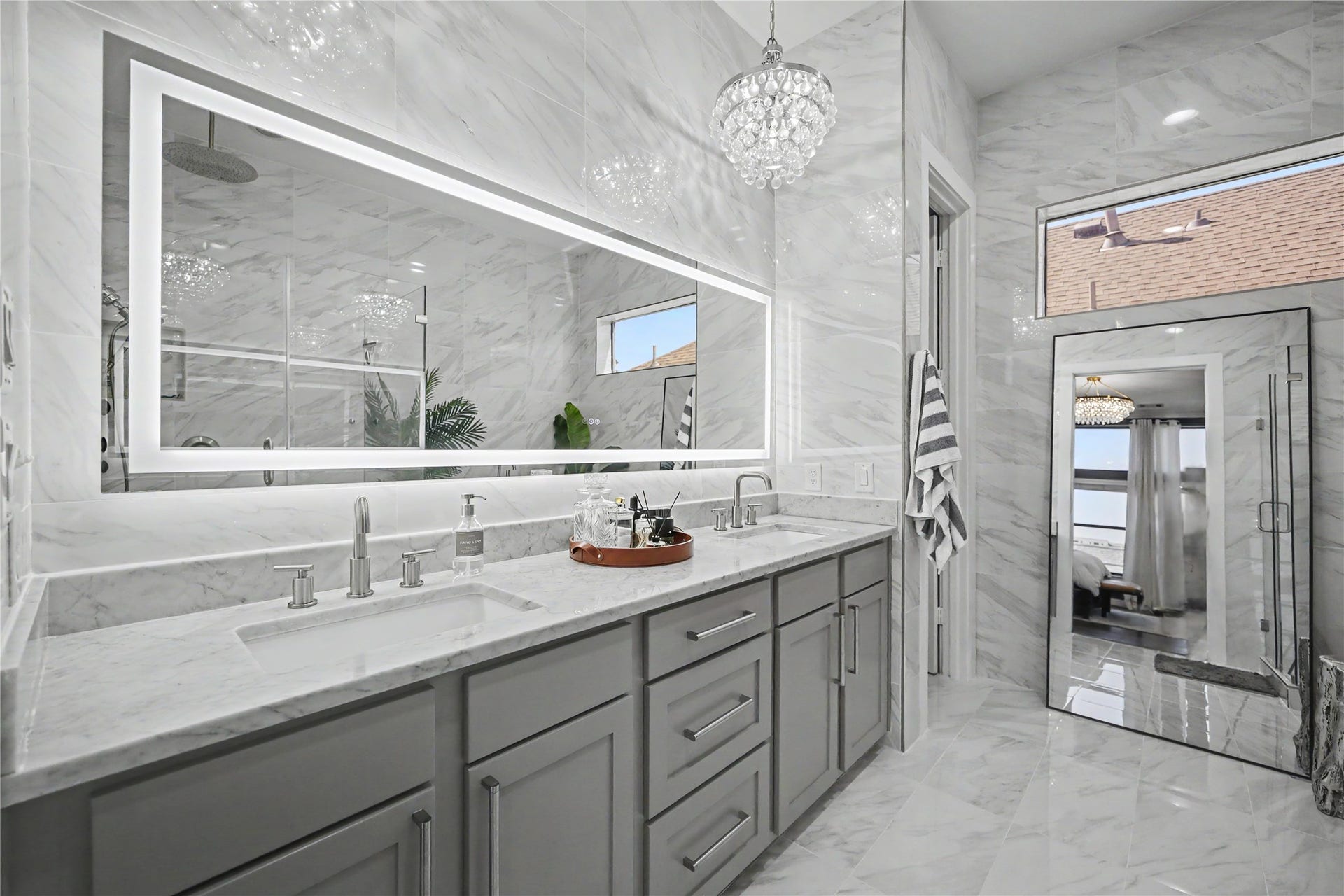 Wall-to-wall mirror with ample counter space.