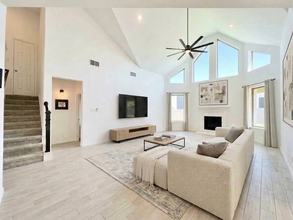 8822 SPINNING MILL DRIVE, Missouri City, TX 77459 ANOTHER VIEW SHOWS THE ROOMS DRAMATIC WINDOWS, FIREPLACE, AND OPEN CONNECTION TO THE REST OF THE HOME.