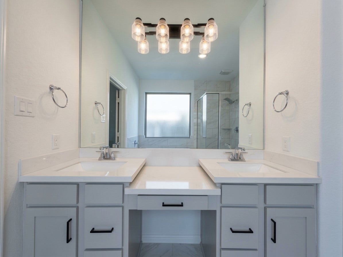 8822 SPINNING MILL DRIVE, Missouri City, TX 77459 TWO SINKS FRAME A CENTER SEATED VANITY, WITH DRAWERS AND CABINETS FOR STORAGE.