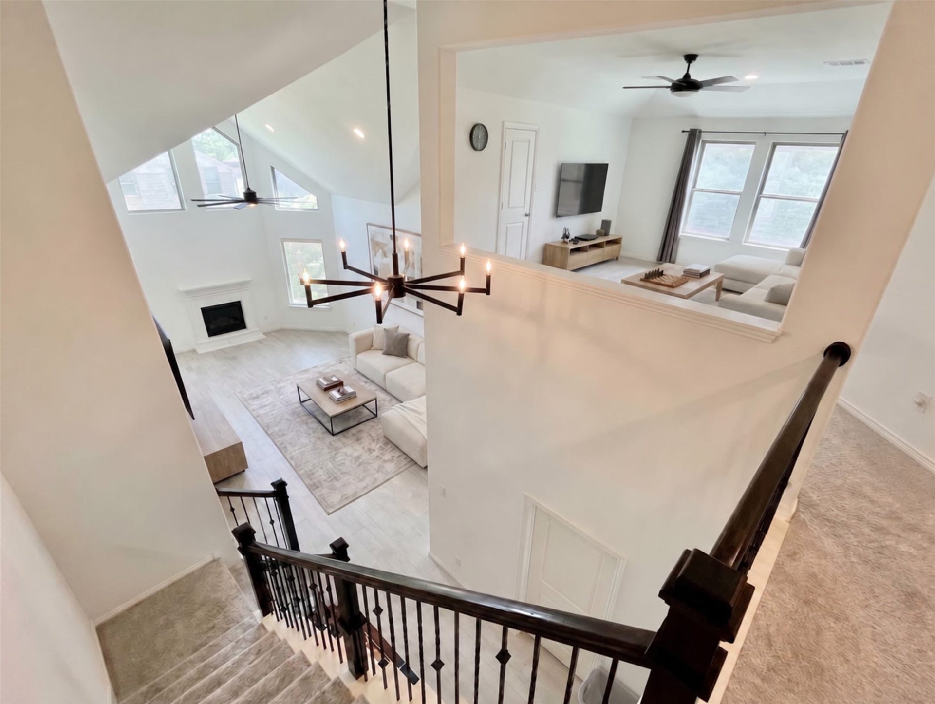 8822 SPINNING MILL DRIVE, Missouri City, TX 77459 FROM THE SECOND FLOOR, THE STAIRCASE OVERLOOKS THE FAMILY ROOMS SOARING CEILING AND TALL WINDOWS.