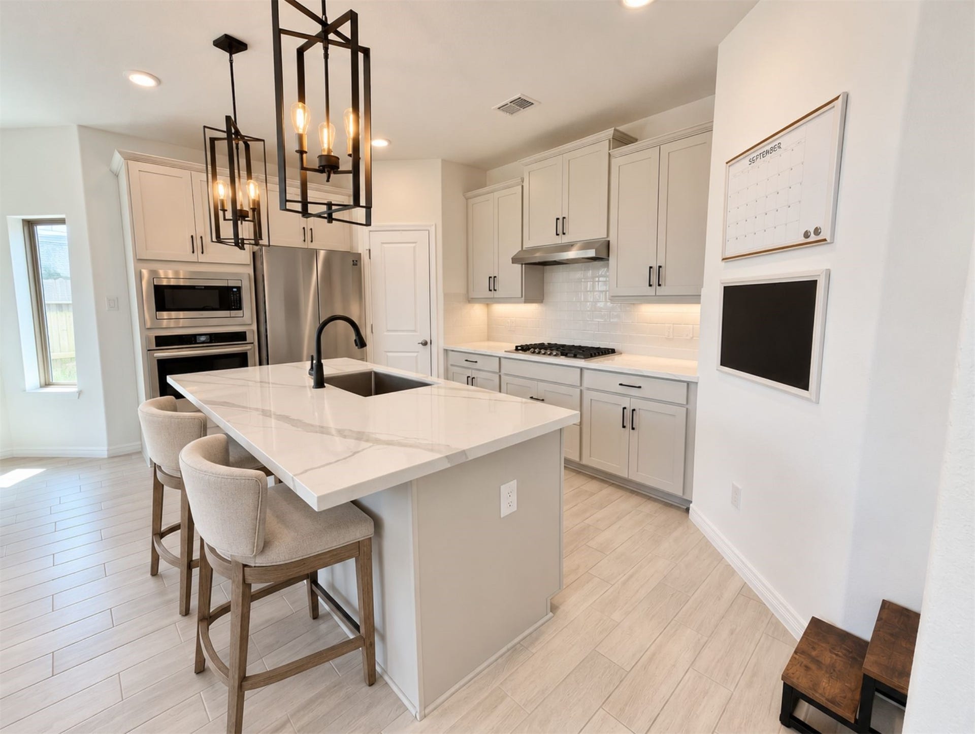 8822 SPINNING MILL DRIVE, Missouri City, TX 77459 THE ISLAND ADDS PREP SPACE AND SEATING, WHILE THE KITCHEN OFFERS A GAS COOKTOP AND BUILT-IN APPLIANCES.