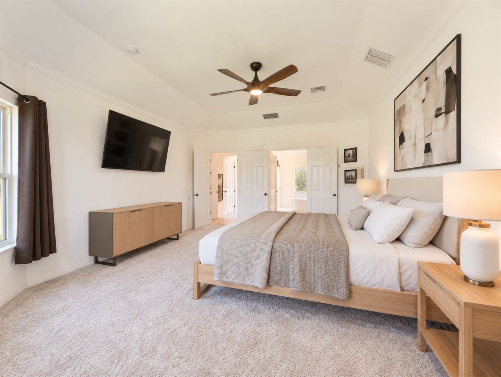 8822 SPINNING MILL DRIVE, Missouri City, TX 77459 ANOTHER VIEW OF THE SPACIOUS PRIMARY BEDROOM SHOWS ITS CEILING FAN, CARPET, AND ROOM FOR A SEATING AREA.