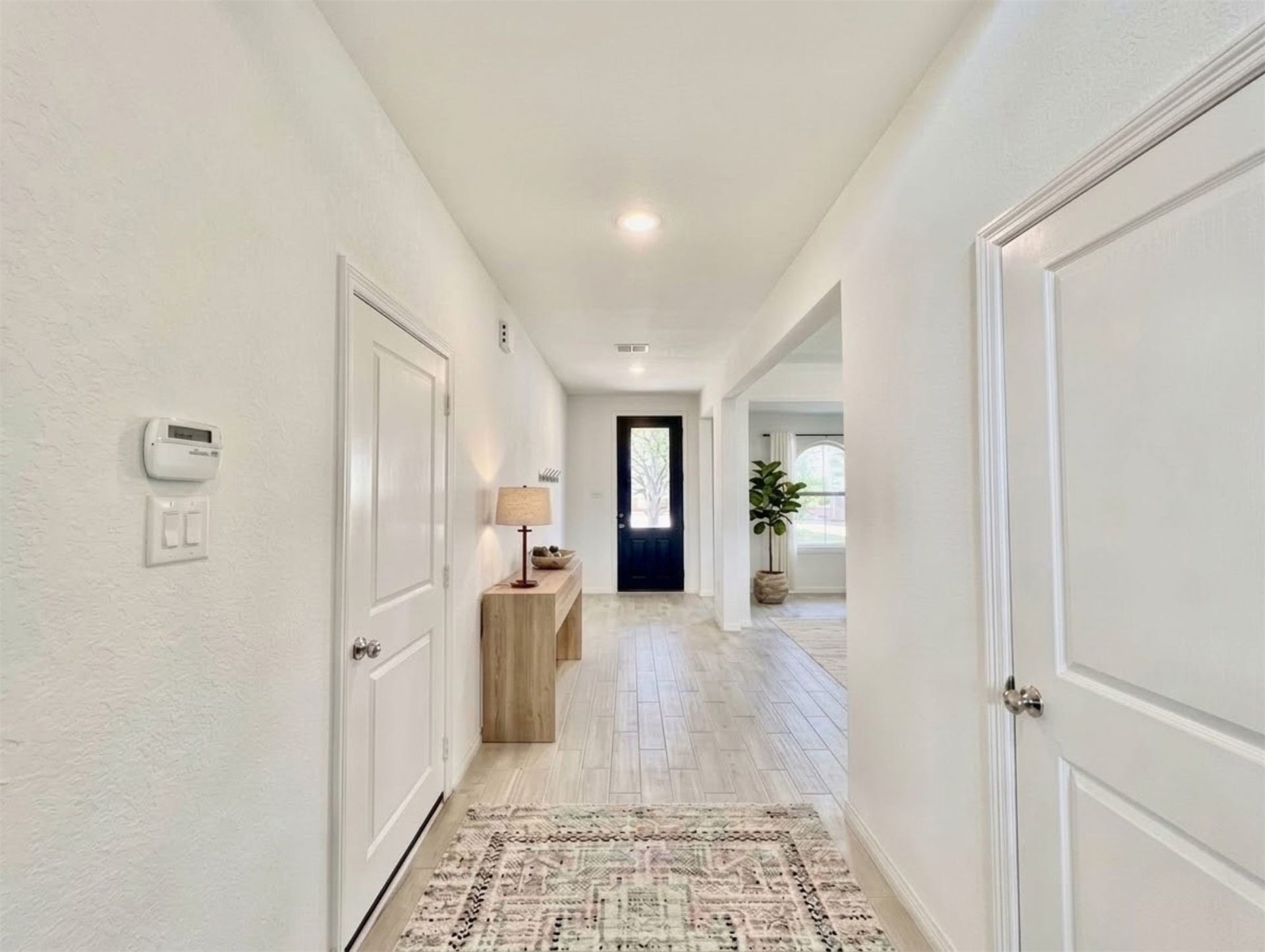 8822 SPINNING MILL DRIVE, Missouri City, TX 77459 A VIEW BACK TOWARD THE FRONT DOOR SHOWS THE HOMES EXTENDED ENTRY AND OPENING TO AN ADJOINING LIVING SPACE.