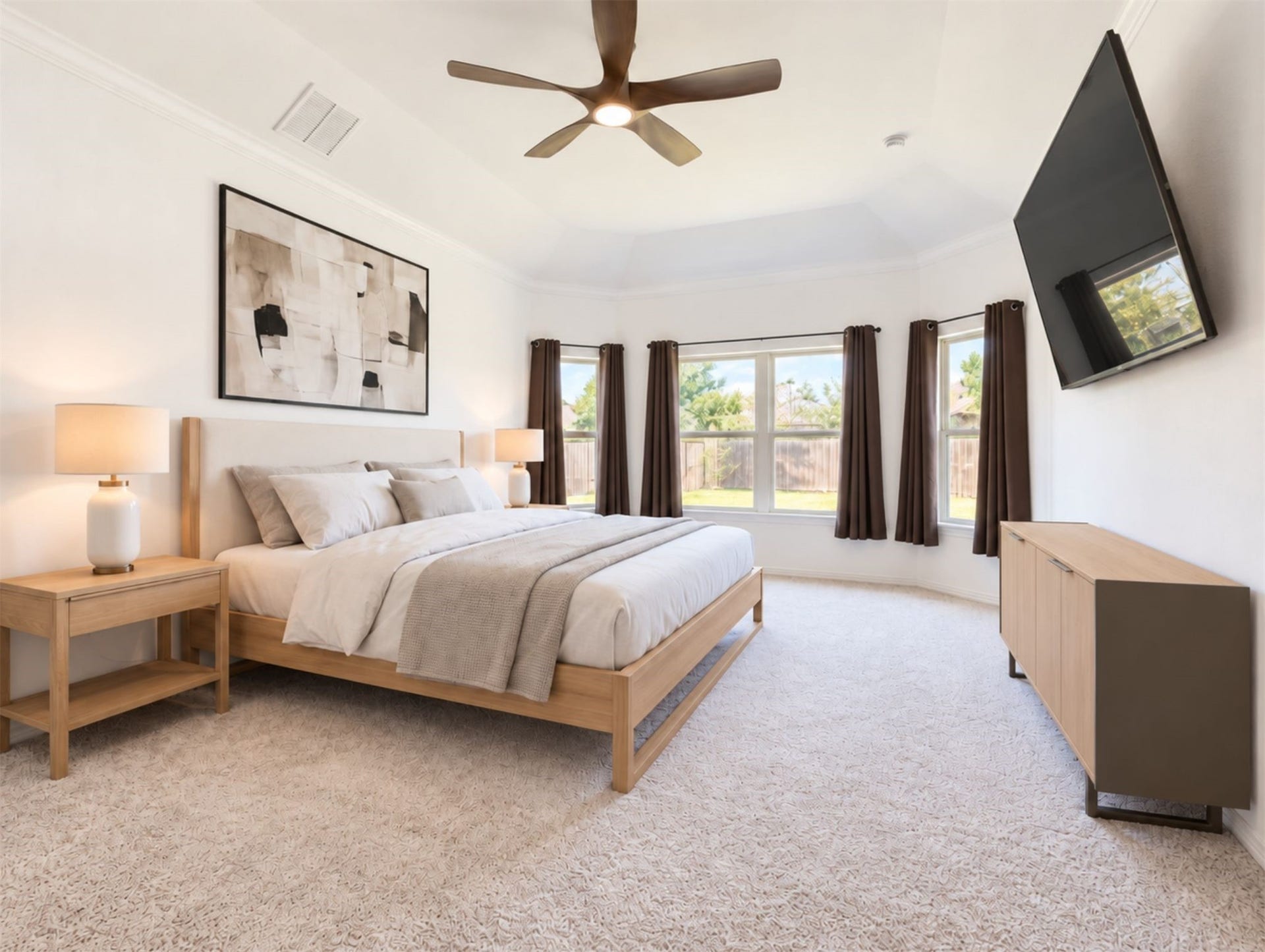 8822 SPINNING MILL DRIVE, Missouri City, TX 77459 THE SPACIOUS PRIMARY BEDROOM FEATURES A CEILING FAN AND A ROW OF WINDOWS OVERLOOKING THE BACKYARD.
