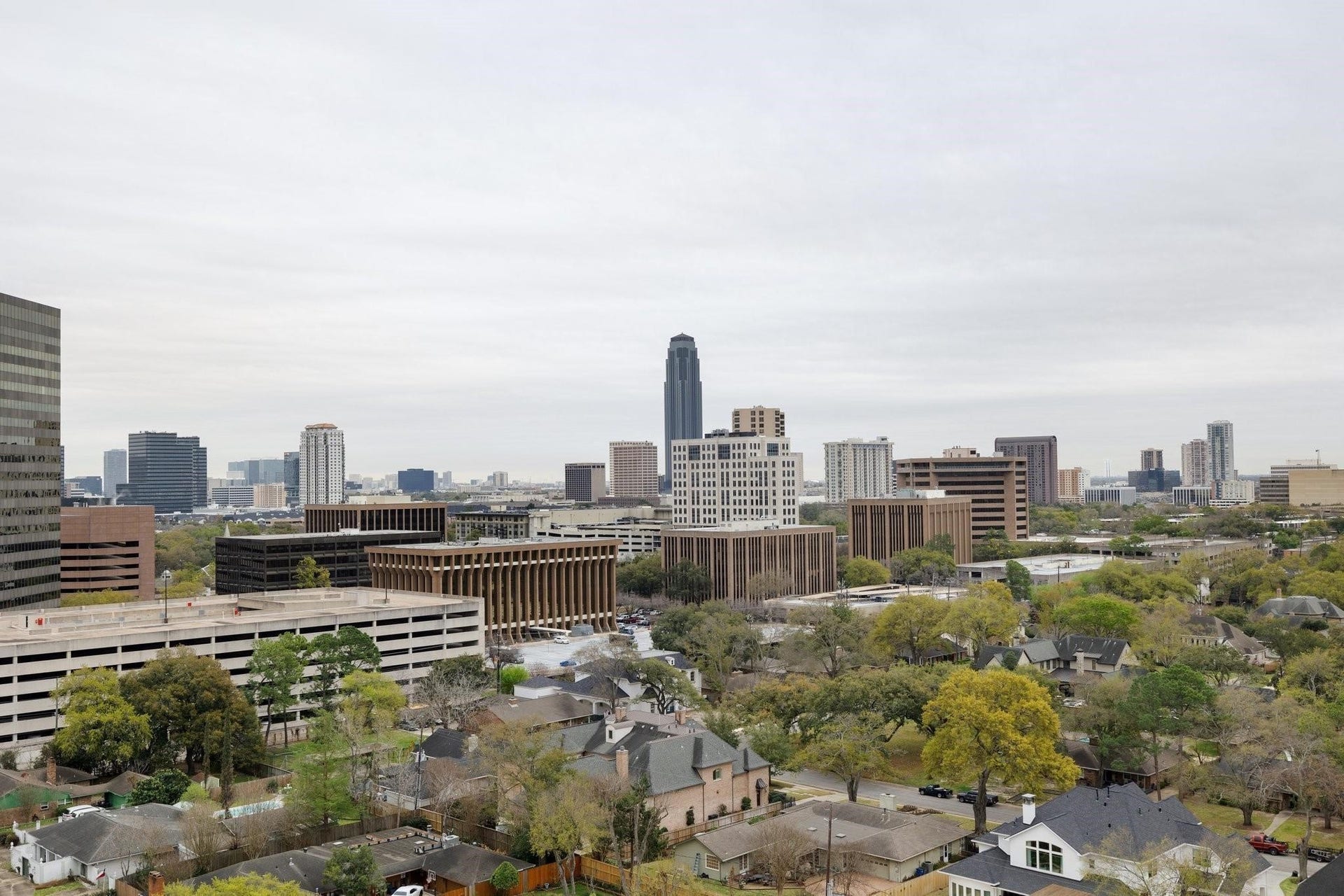 5656 San Felipe Street, Unit 701, Houston, TX 77056 Expansive SouthEast-facing views from the formal dining where walls of windows frame the surrounding skyline and lush residential landscape.