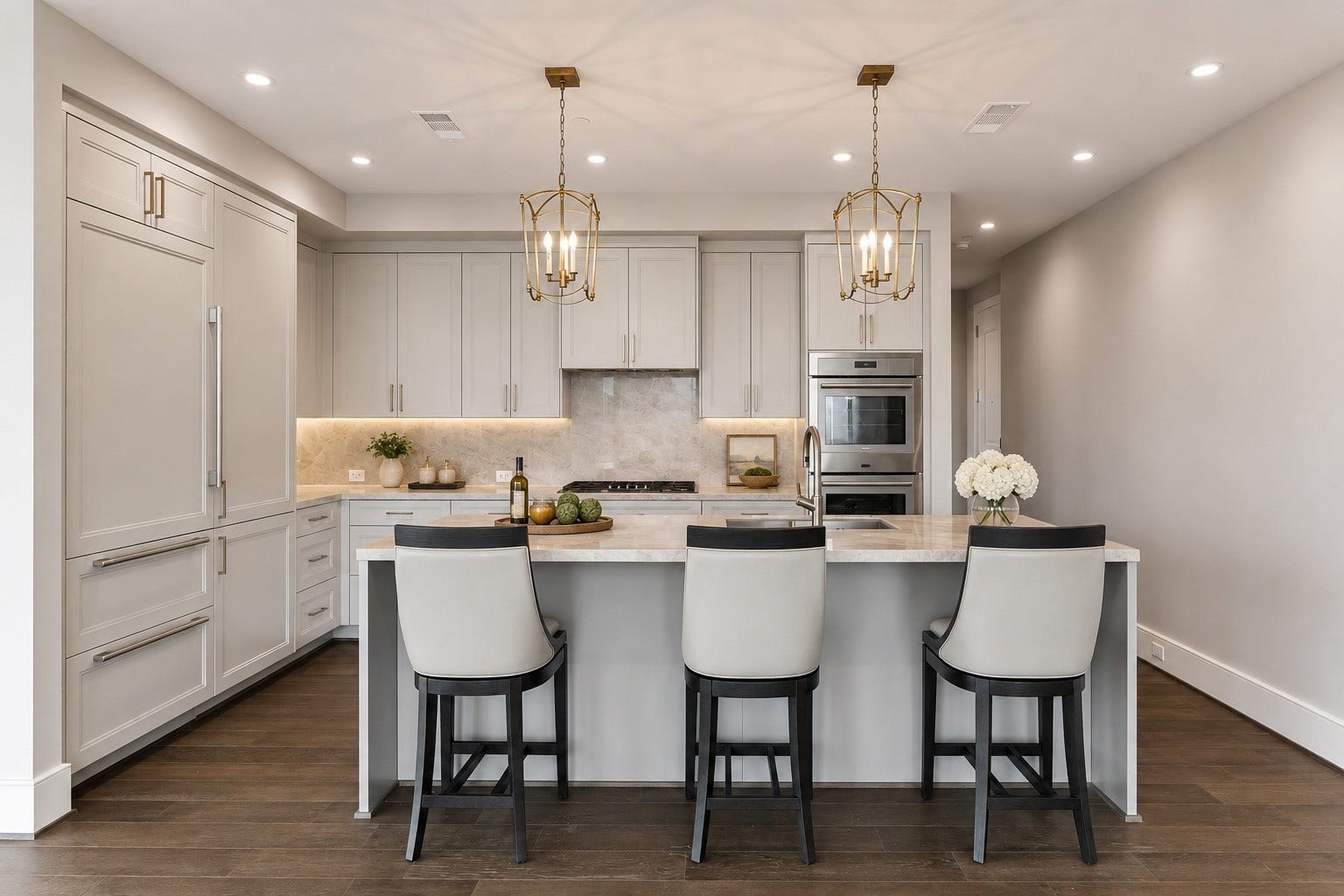 5656 San Felipe Street, Unit 701, Houston, TX 77056 A beautiful appointed kitchen combines elegance and everyday functionality. Generous center island doubles ad a convenient breakfast bar for morning breakfast or casual dining. Sub-Zero refrigerator and elegant pendant lighting and under cabinets lights adding warmth and architectural interest above the island.