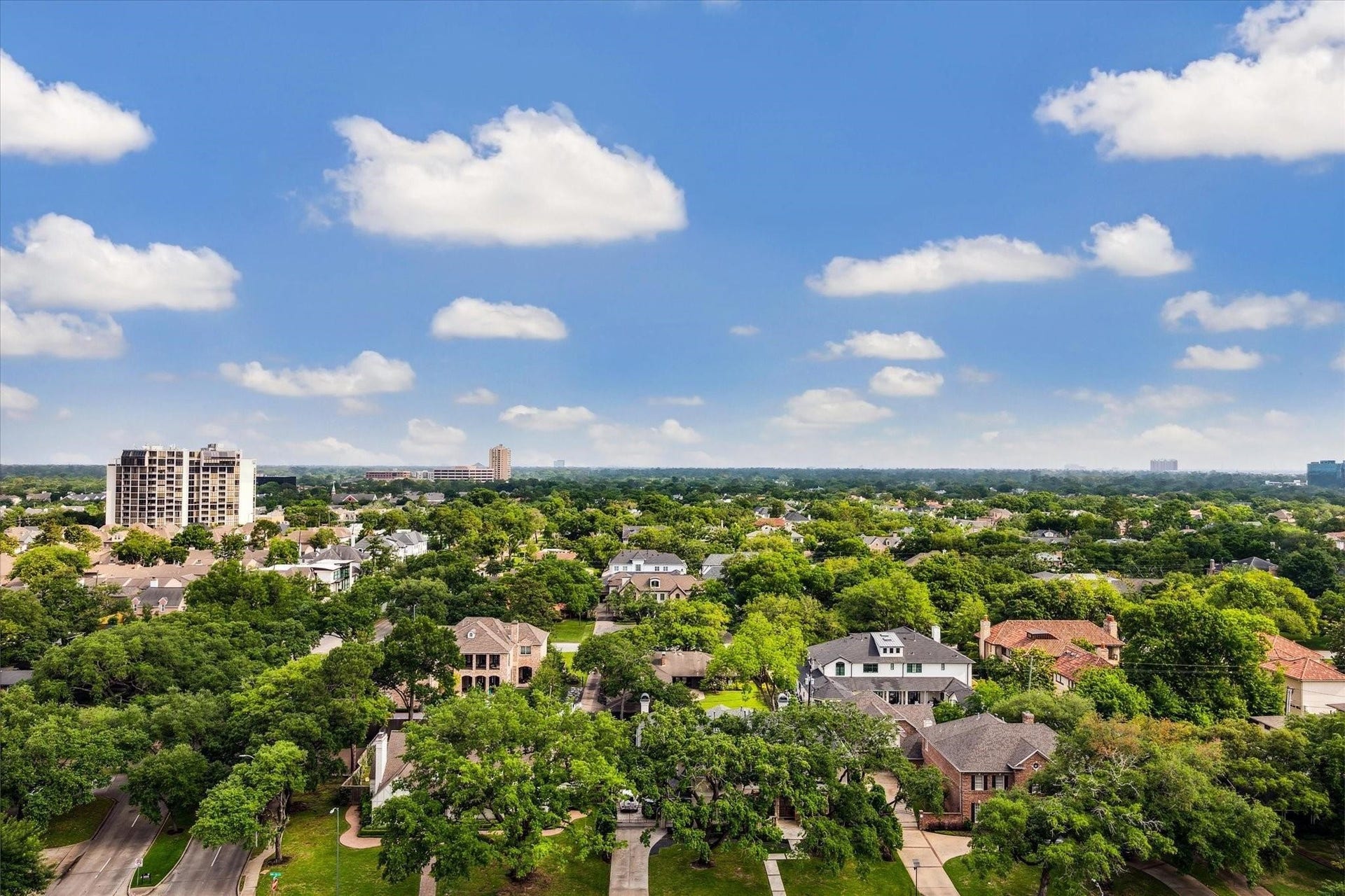 5656 San Felipe Street, Unit 701, Houston, TX 77056 Enjoy the dynamic cityscape and spectacular treetop views from the living room terrace