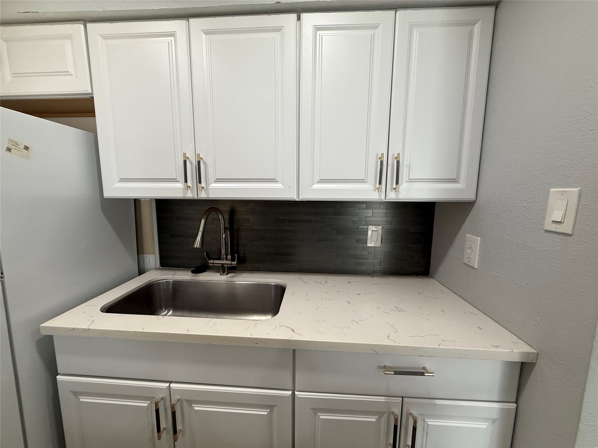 9550 Deering Drive, #210, Houston, TX 77036 Updated backsplash, faucet and cabinet hardware.
