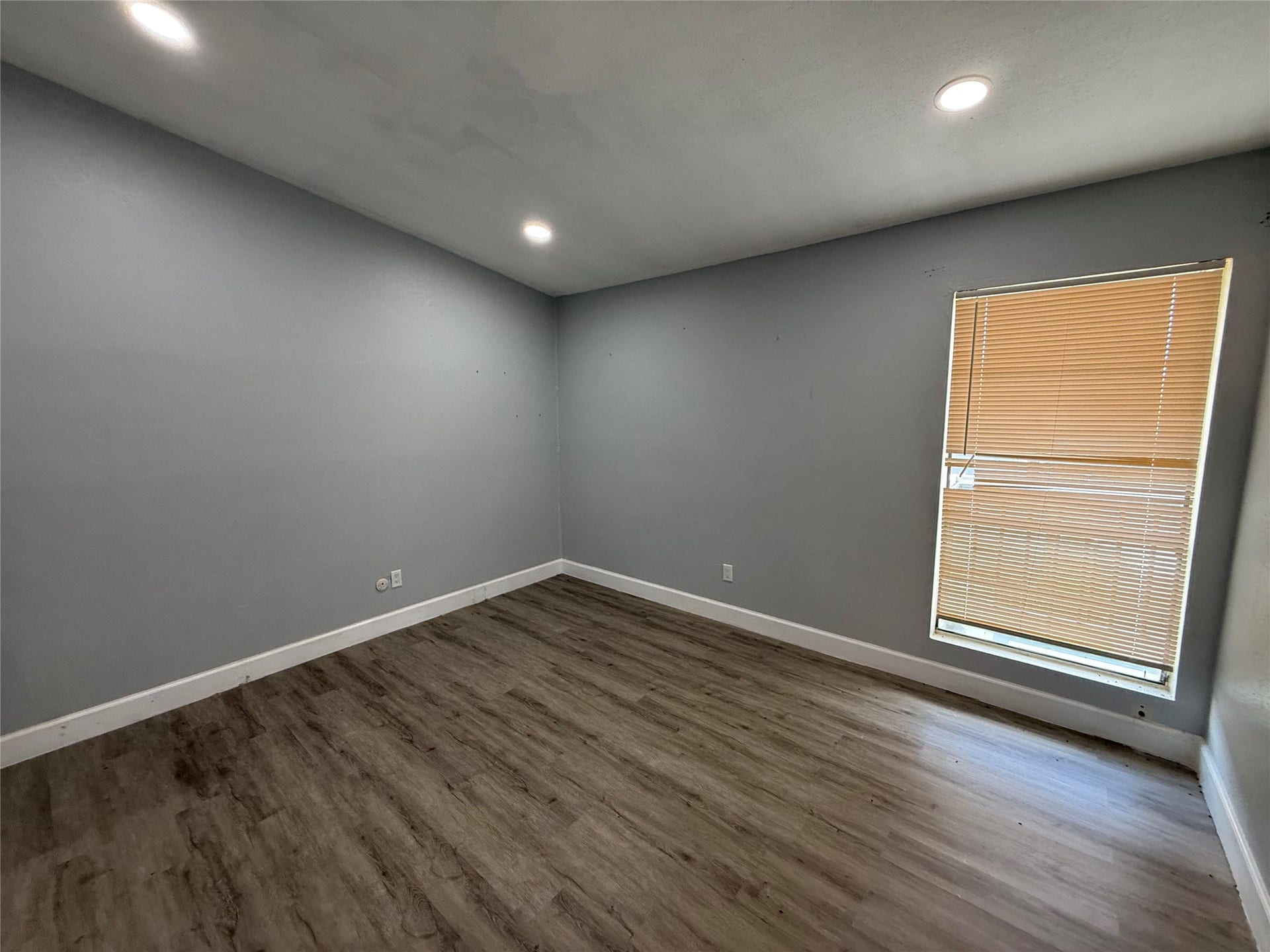 9550 Deering Drive, #210, Houston, TX 77036 Bedroom with recessed lighting and window overlooking the courtyard.