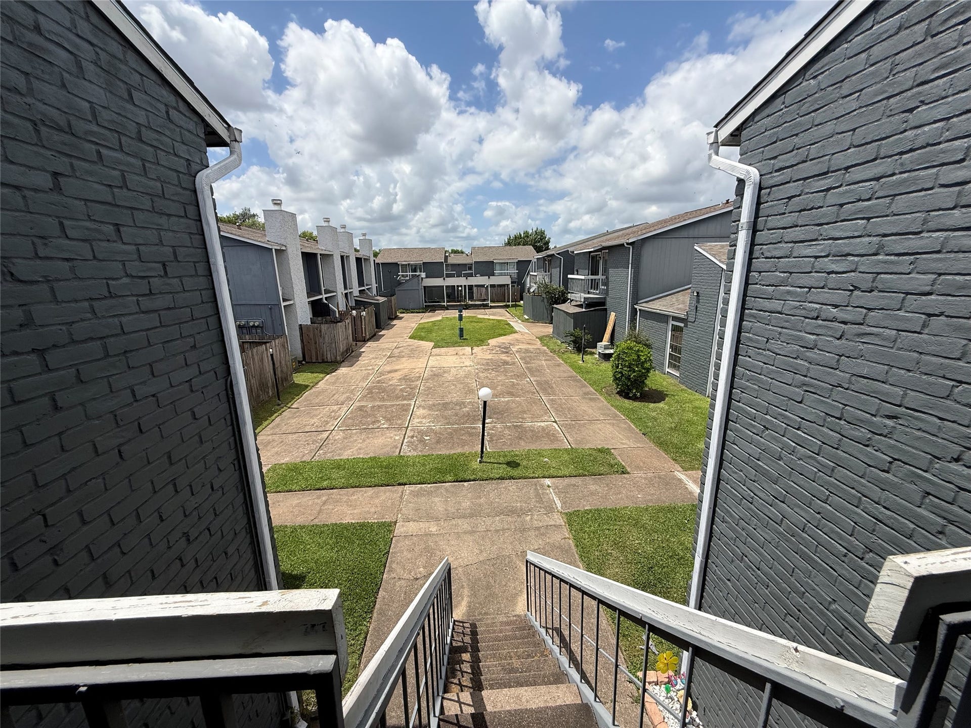 9550 Deering Drive, #210, Houston, TX 77036 Front entry and stairs lead directly into community courtyard.