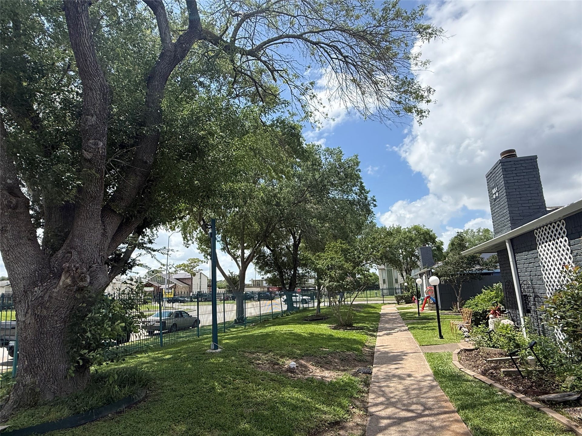 9550 Deering Drive, #210, Houston, TX 77036 Huge trees provide shade from the Texas heat when you take a walk inside the gated complex.