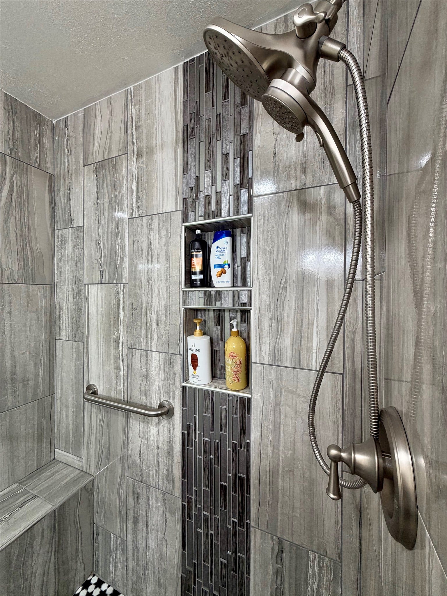 5420 Avenue O, Galveston, TX 77551 Custom tiled shower with bench, brushed nickel hardware and double shampoo cubbies