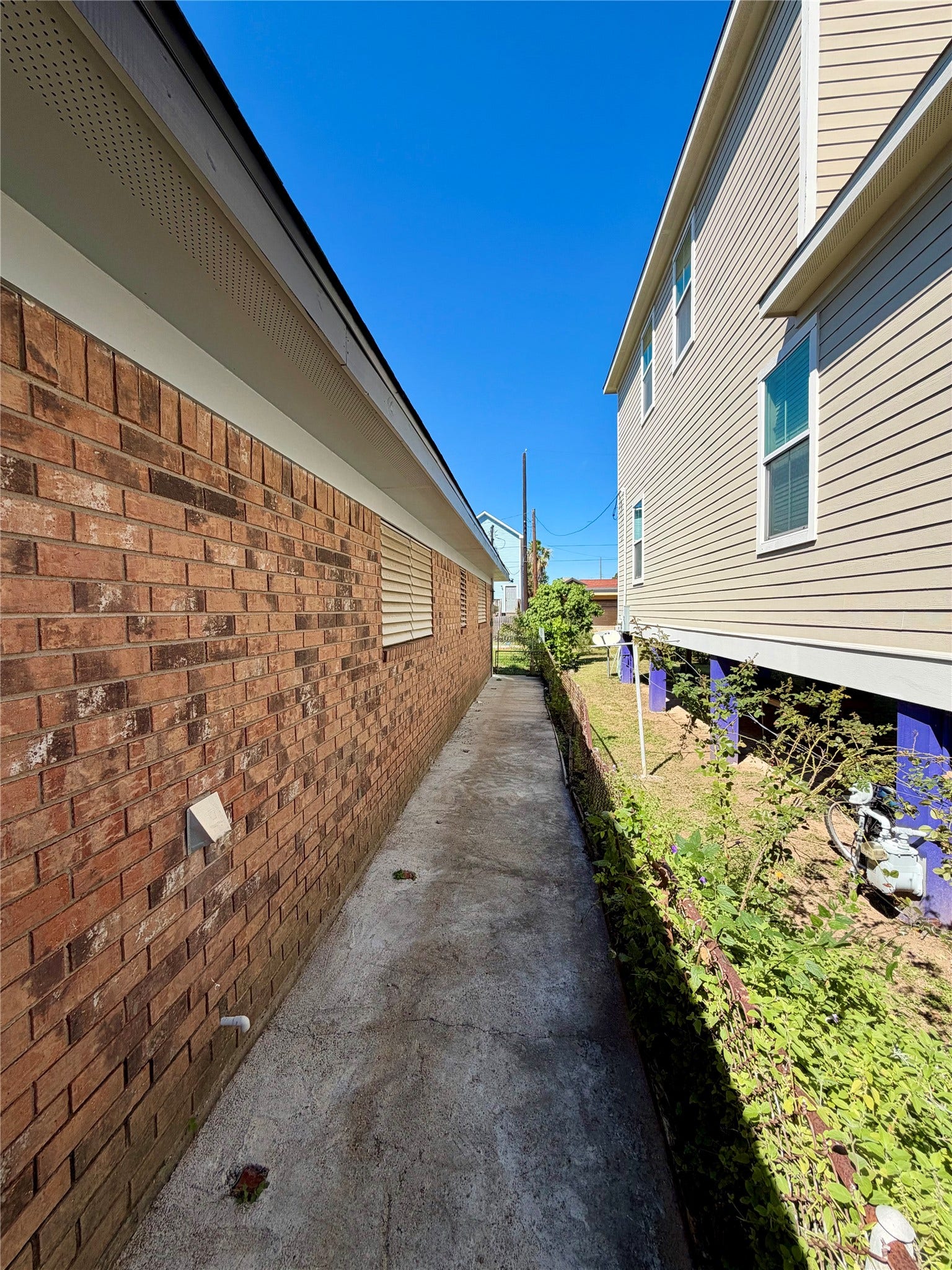 5420 Avenue O, Galveston, TX 77551 East side of the brick home with convenient, paved walkway