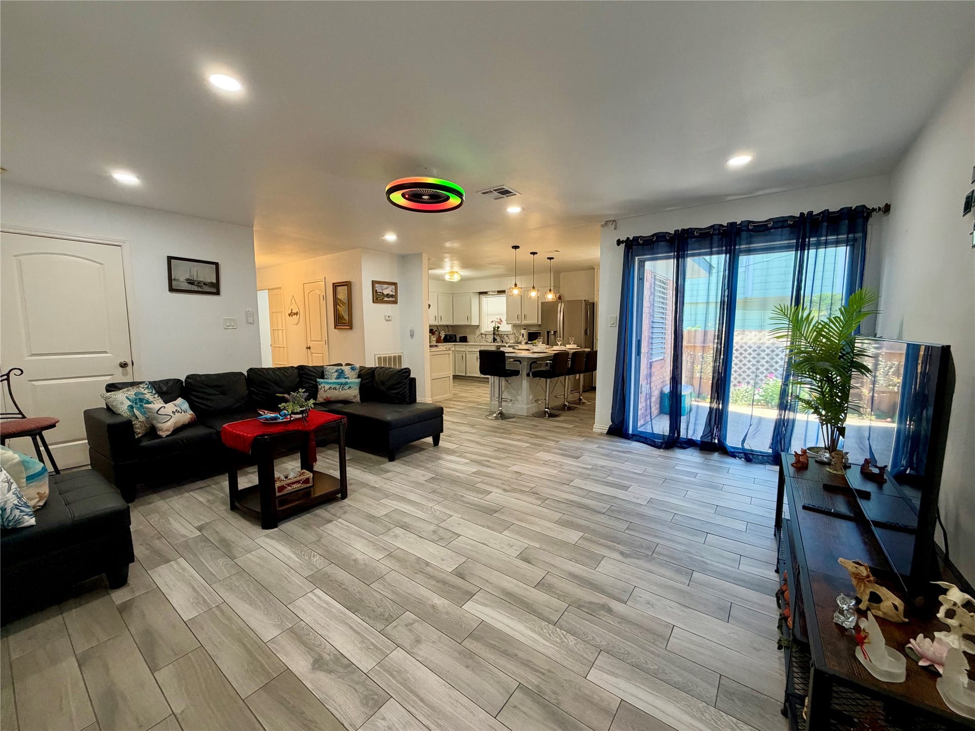 5420 Avenue O, Galveston, TX 77551 Large living space with patio access. Yes, the ceiling fan light changes colors! Garage access through the door on the left.