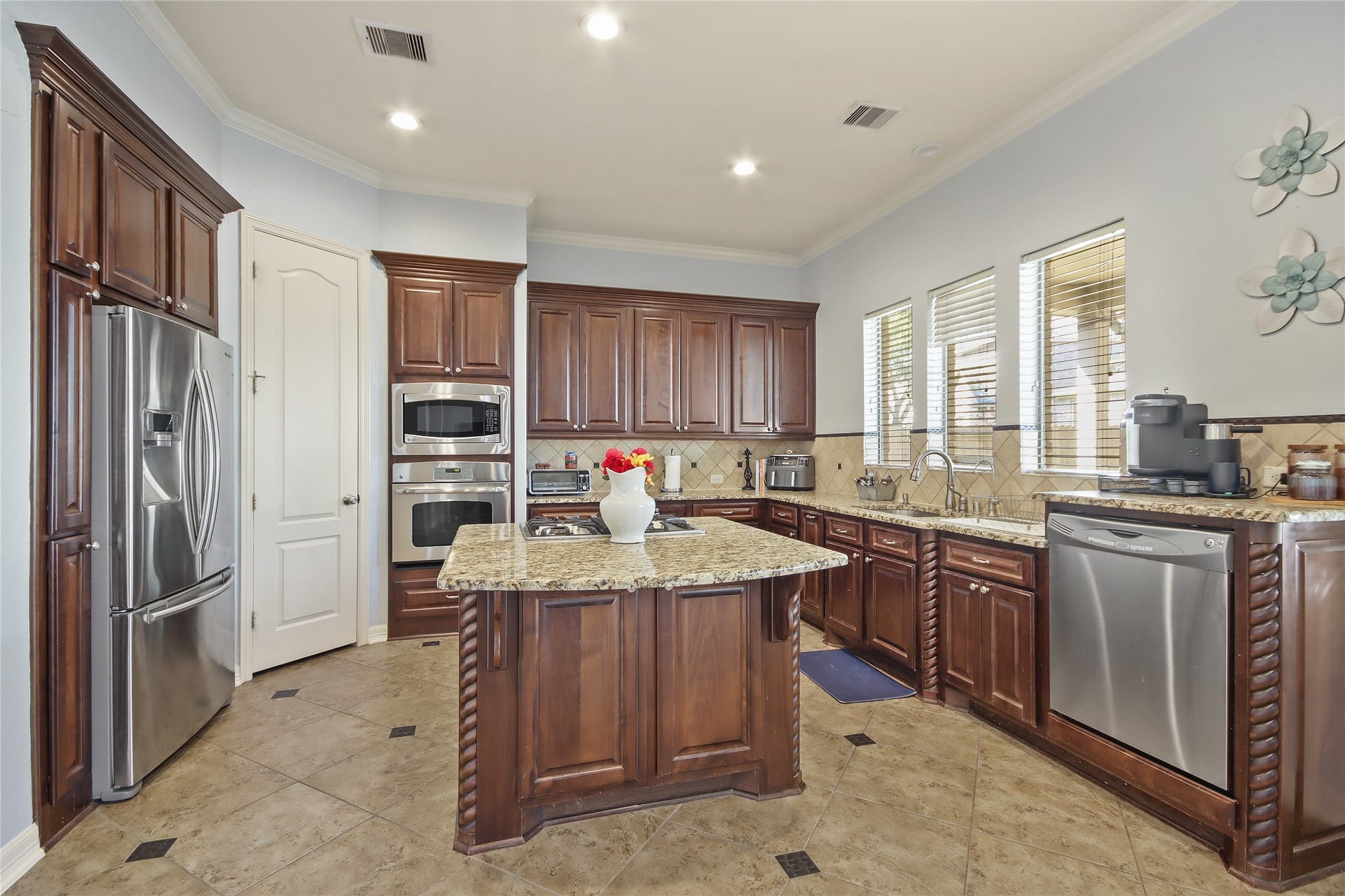 27906 Iberville Glen Dr, Katy, TX 77494 The kitchen includes modern stainless steel appliances, including the refrigerator.