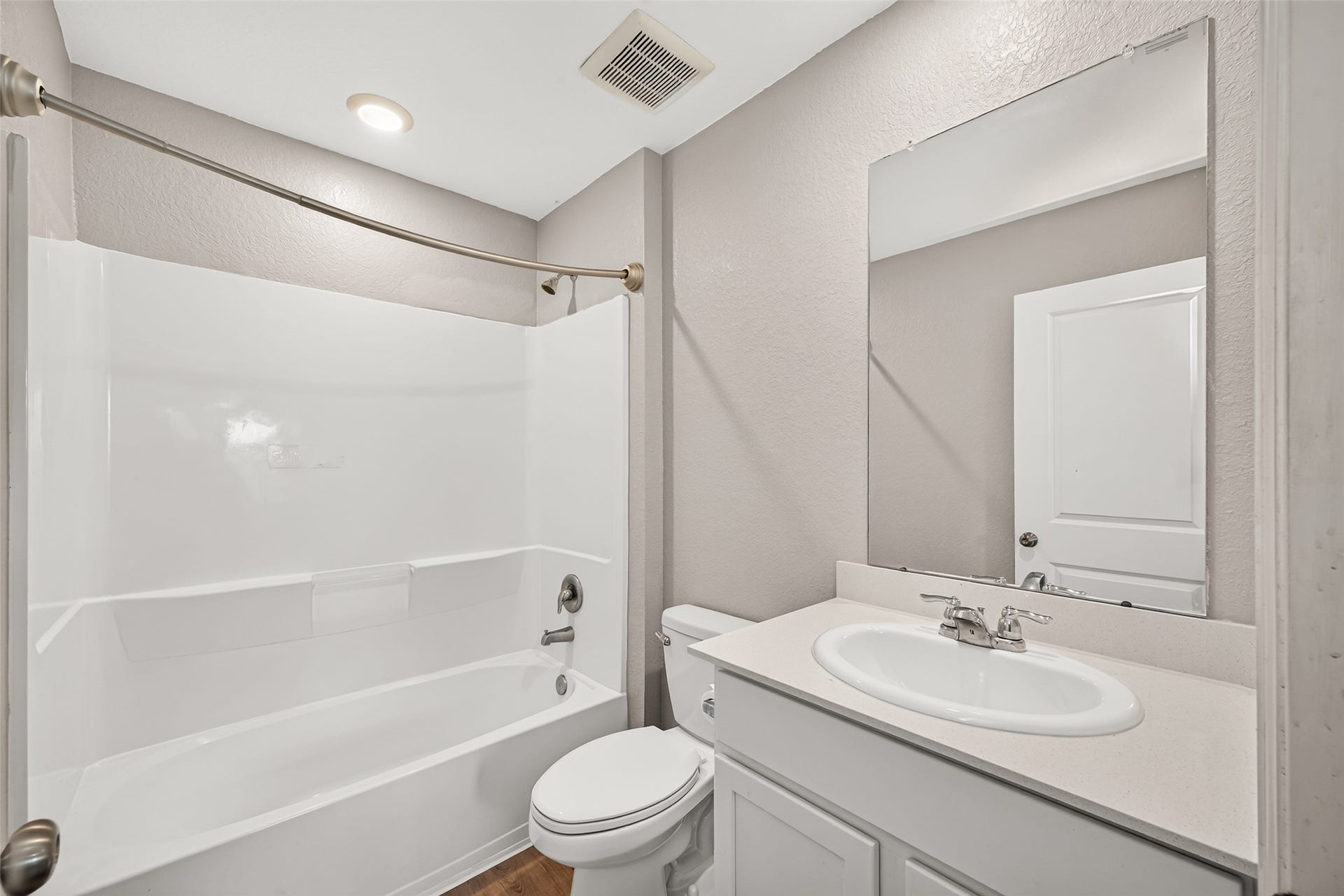 19494 Rosali Meadow Drive, New Caney, TX 77357 Modern bathroom featuring a sleek white vanity, spacious tub-shower combination, and warm neutral walls, creating a welcoming and functional space.