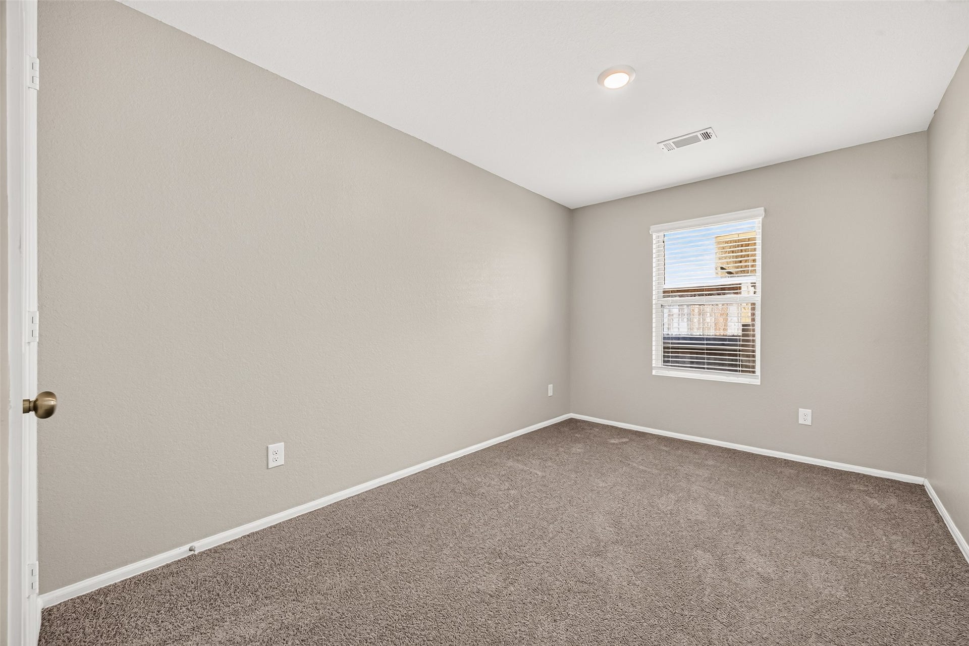 19494 Rosali Meadow Drive, New Caney, TX 77357 Bright and cozy bedroom featuring soft carpet flooring, neutral walls, and a window filling the space with natural light.