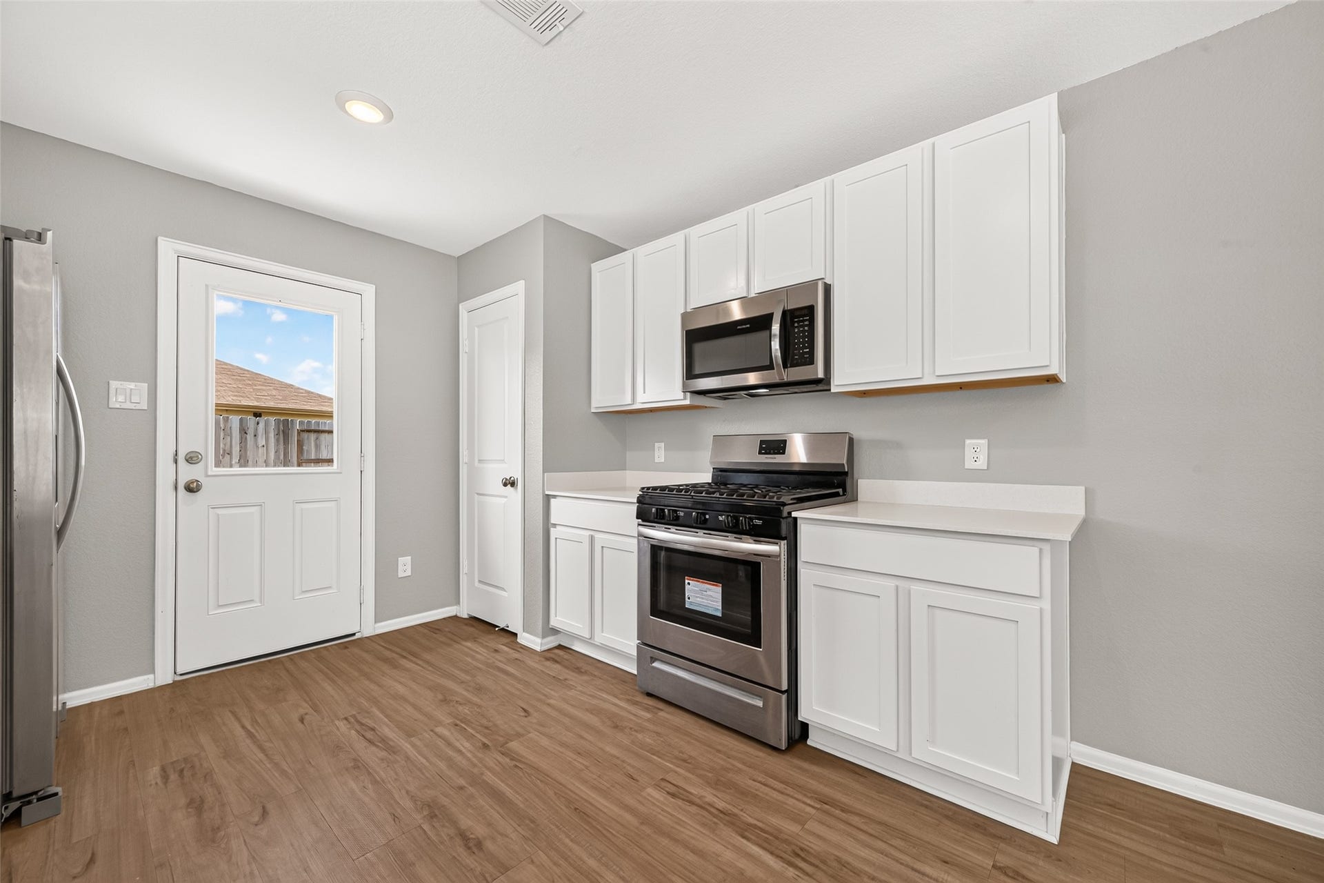 19494 Rosali Meadow Drive, New Caney, TX 77357 Crisp white cabinetry, and warm wood flooring, offering a seamless blend of style and functionality.