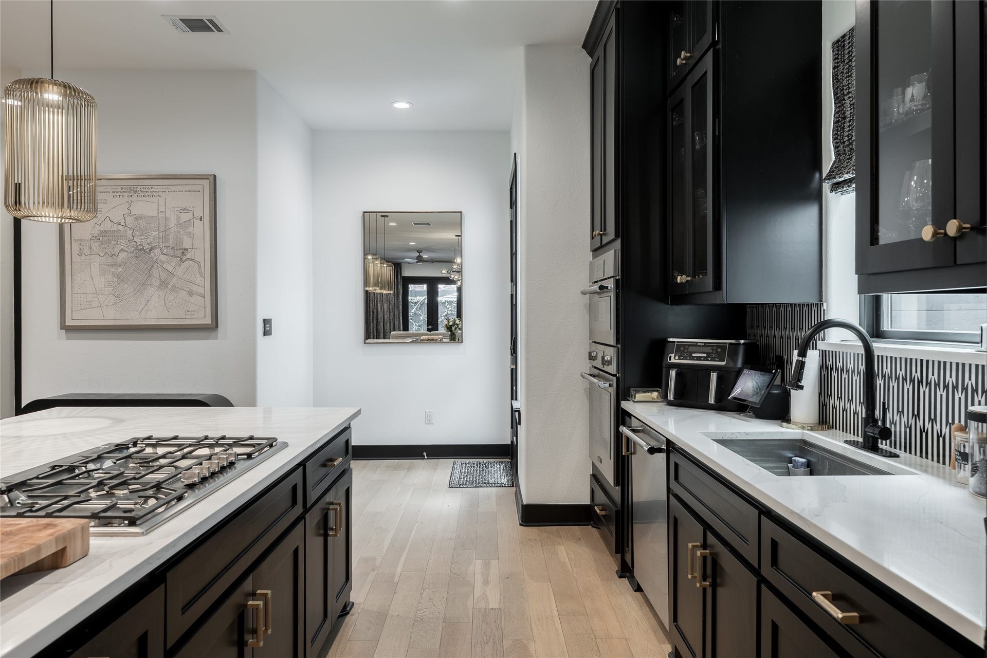 906 Knox Street, Houston, TX 77007 Every detail of the renovated kitchen feels considered, from the extensive storage and expansive countertops to the integrated appliances and bold backsplash that brings character to the space.