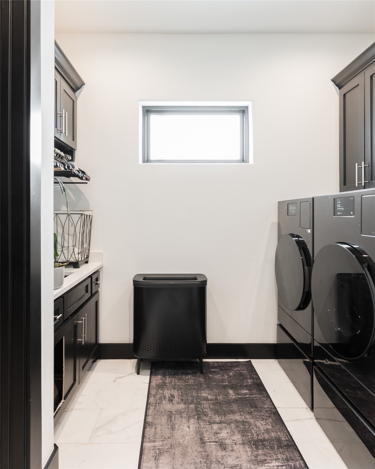 906 Knox Street, Houston, TX 77007 Even the utility spaces reflect the homes renovation, with the laundry room carrying through the dark cabinetry, clean finishes, and generous storage found throughout.