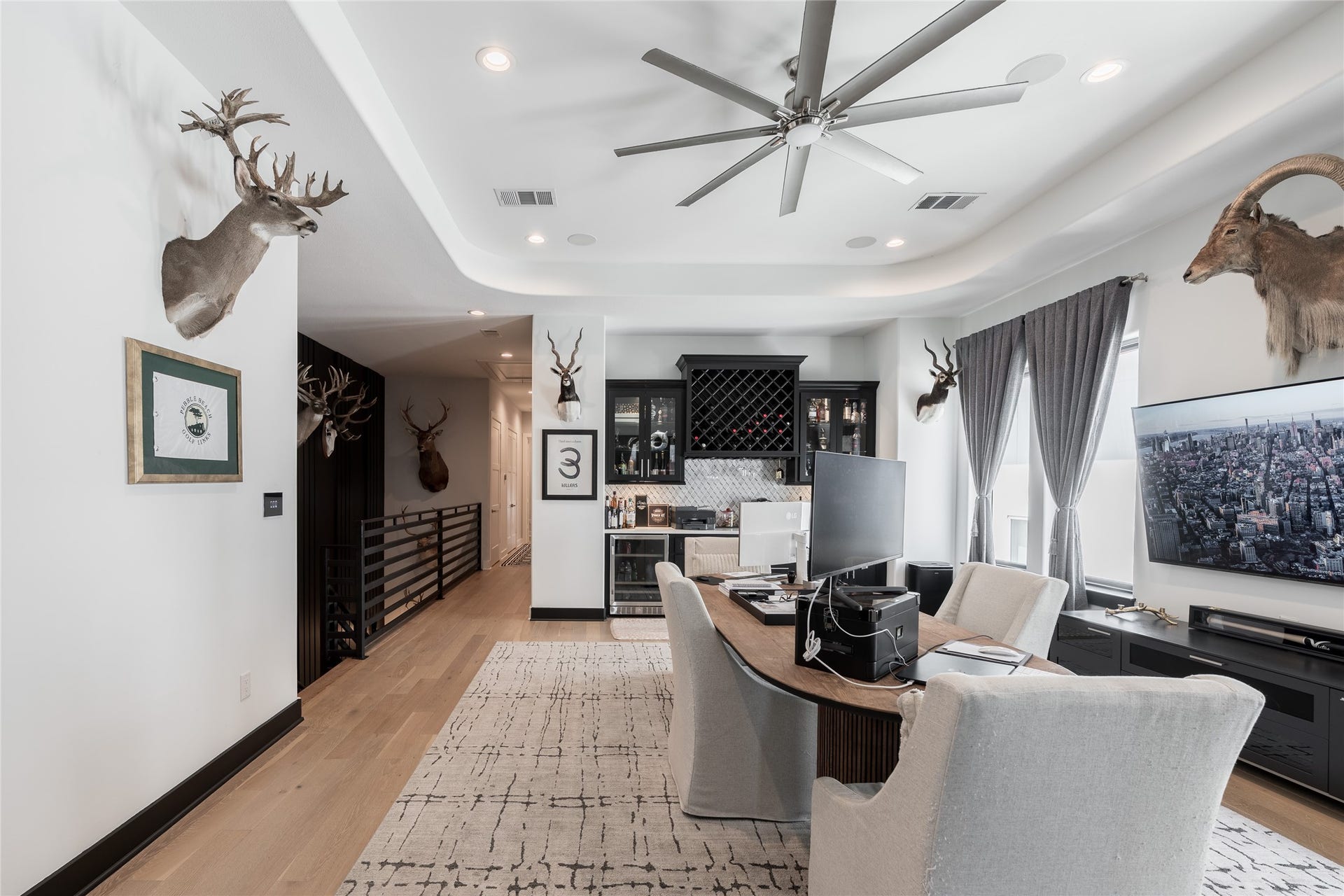 906 Knox Street, Houston, TX 77007 Purpose-built for entertaining, this upper-level retreat pairs a generous gathering space with a fully integrated bar, wine display, and beverage center.