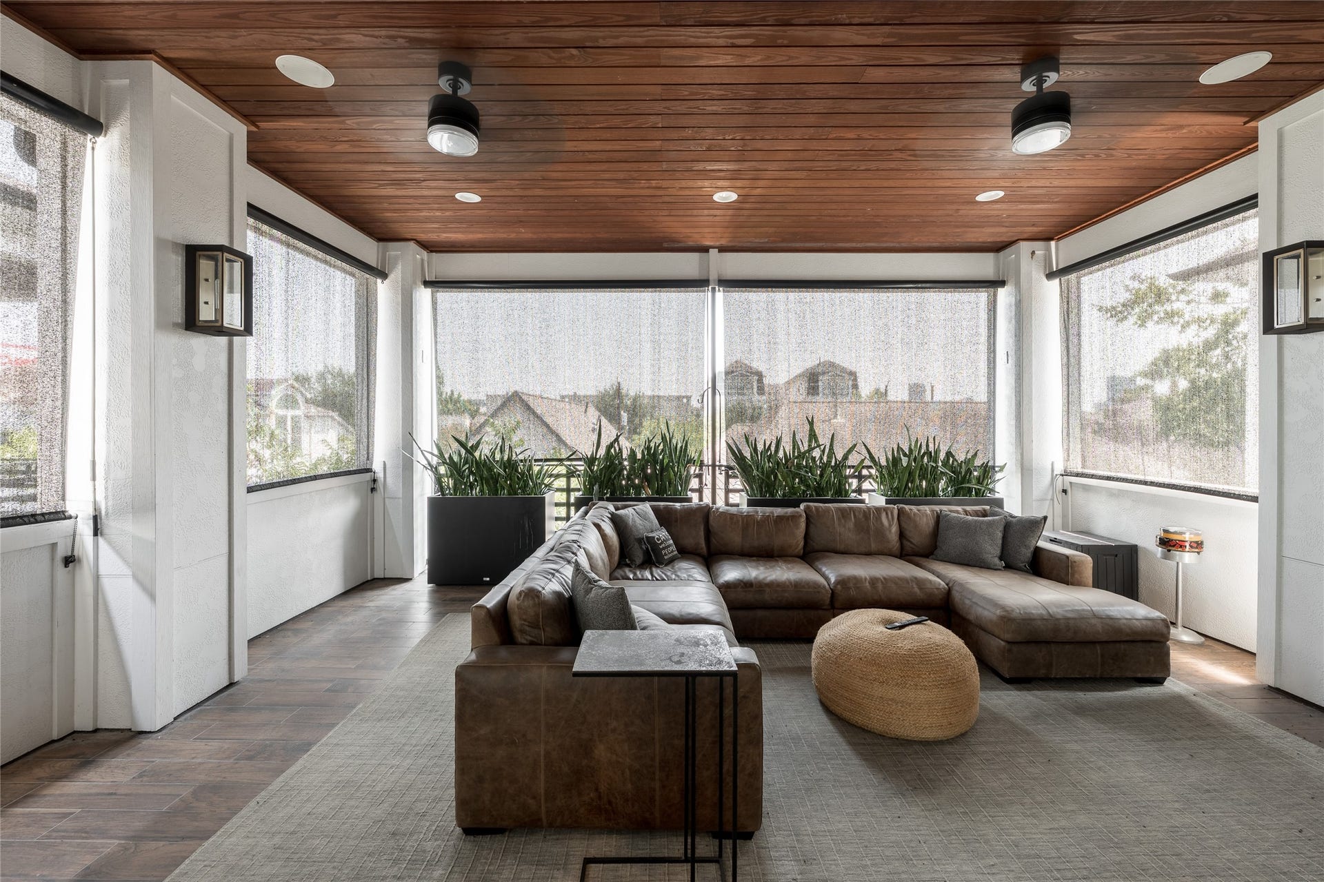 906 Knox Street, Houston, TX 77007 The covered rooftop retreat lives like an outdoor living room, with a warm wood ceiling, integrated lighting, and motorized perforated shades for added comfort and privacy.