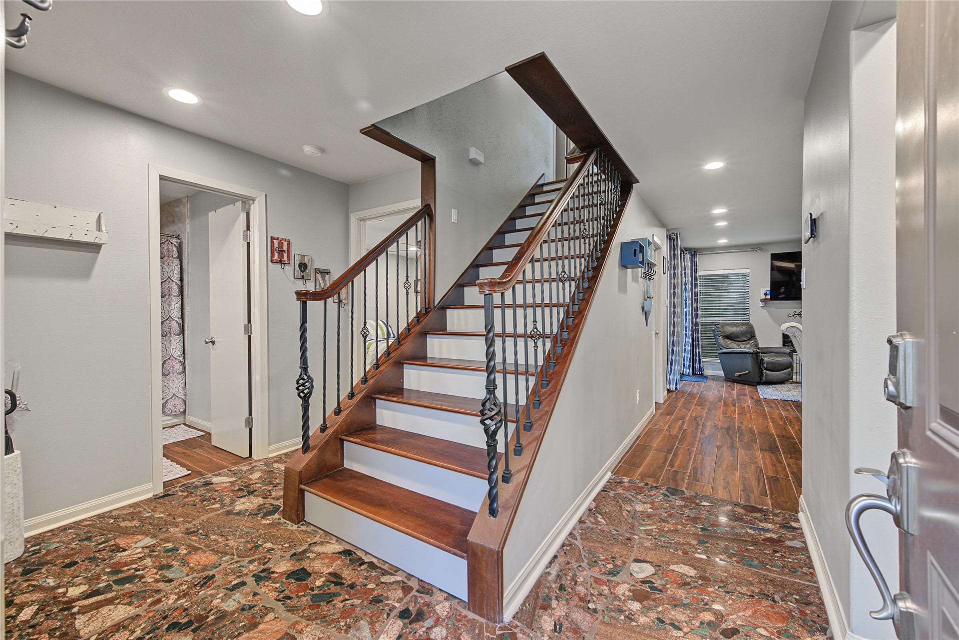 725 Worthshire Street, Houston, TX 77008 Entry foyer featuring wood staircase and decorative tile flooring.