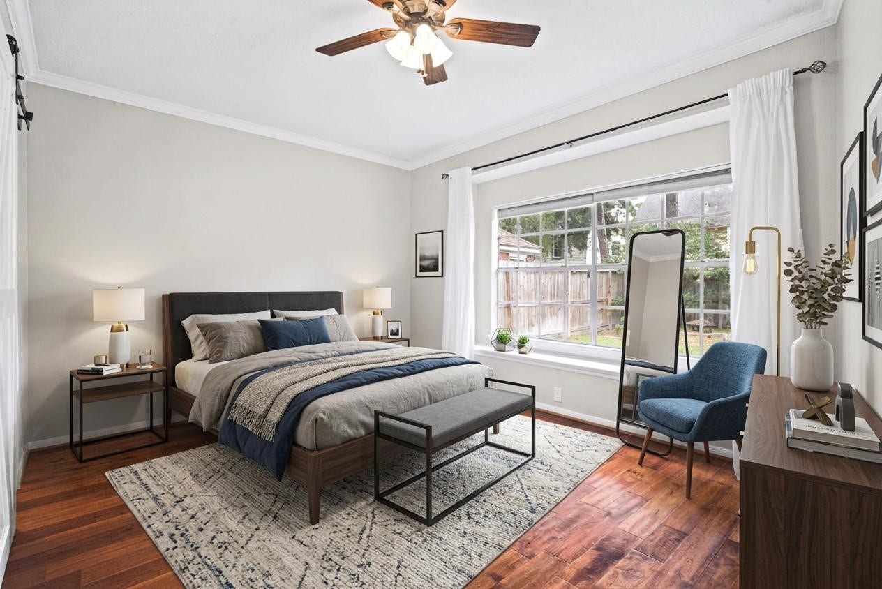 Enjoy the comfort and convenience of a spacious first-floor primary bedroom featuring beautiful engineered wood flooring and a large window that fills the room with natural light. This inviting retreat offers a warm, relaxing atmosphere perfect for unwinding at the end of the day.