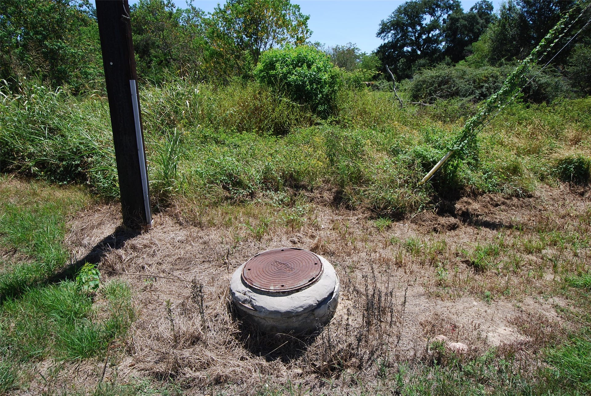 0 Fulshear Katy Road, Fulshear, TX 77441 Okay, not the most appealing photo, but it does show the manhole cover near the front of the property.