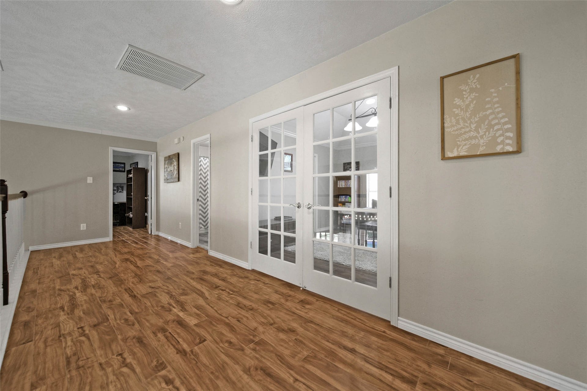 5206 Evergreen Valley Drive, Kingwood, TX 77345 Upstairs you will find nice and wide hallway that leads to three bedrooms and a gameroom with double doors.