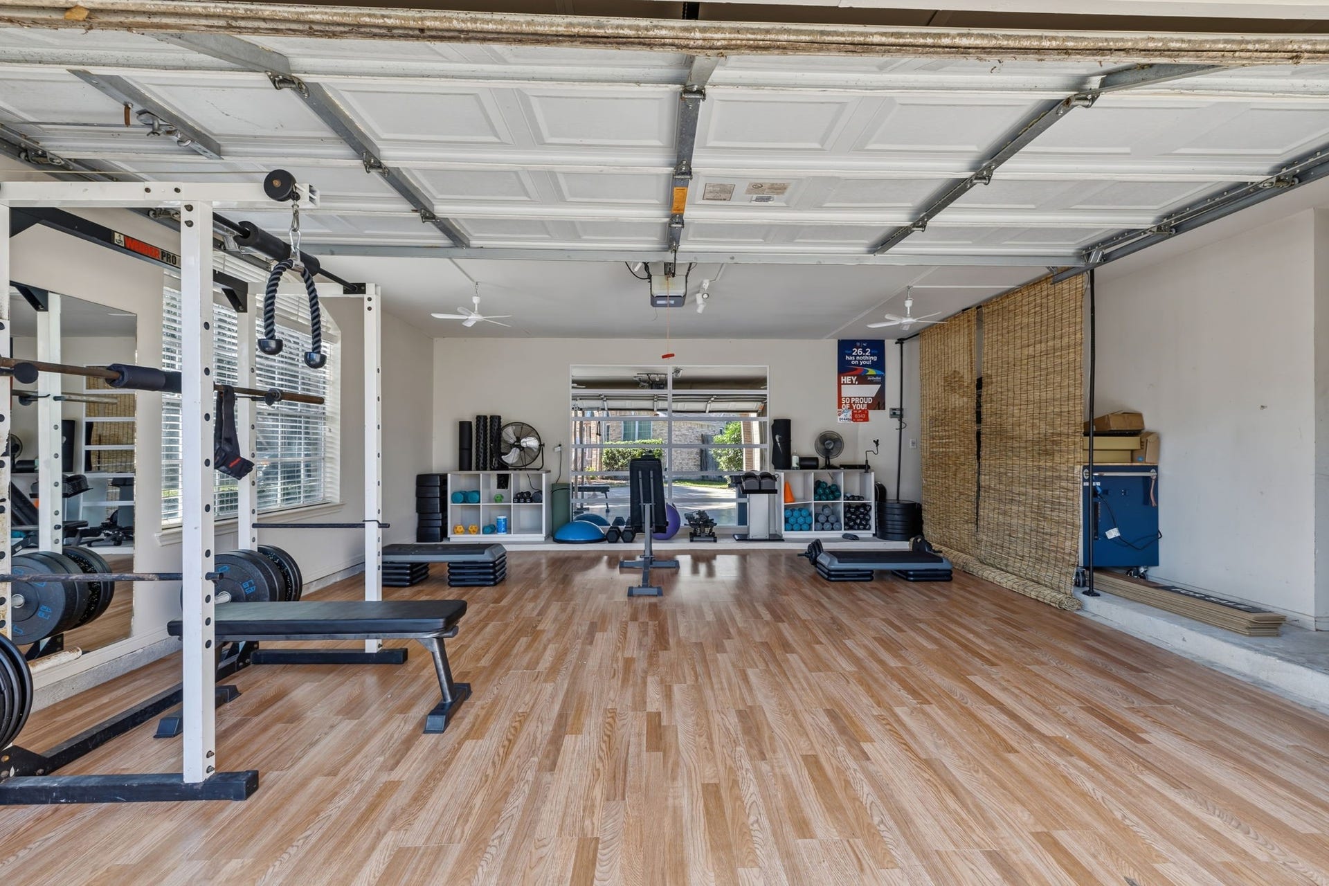 4011 Grayson Court, Missouri City, TX 77459 Spacious home gym with sleek wood flooring, ample natural light, and a variety of fitness equipment for a comprehensive workout experience. Easily converted back to garage if needed.