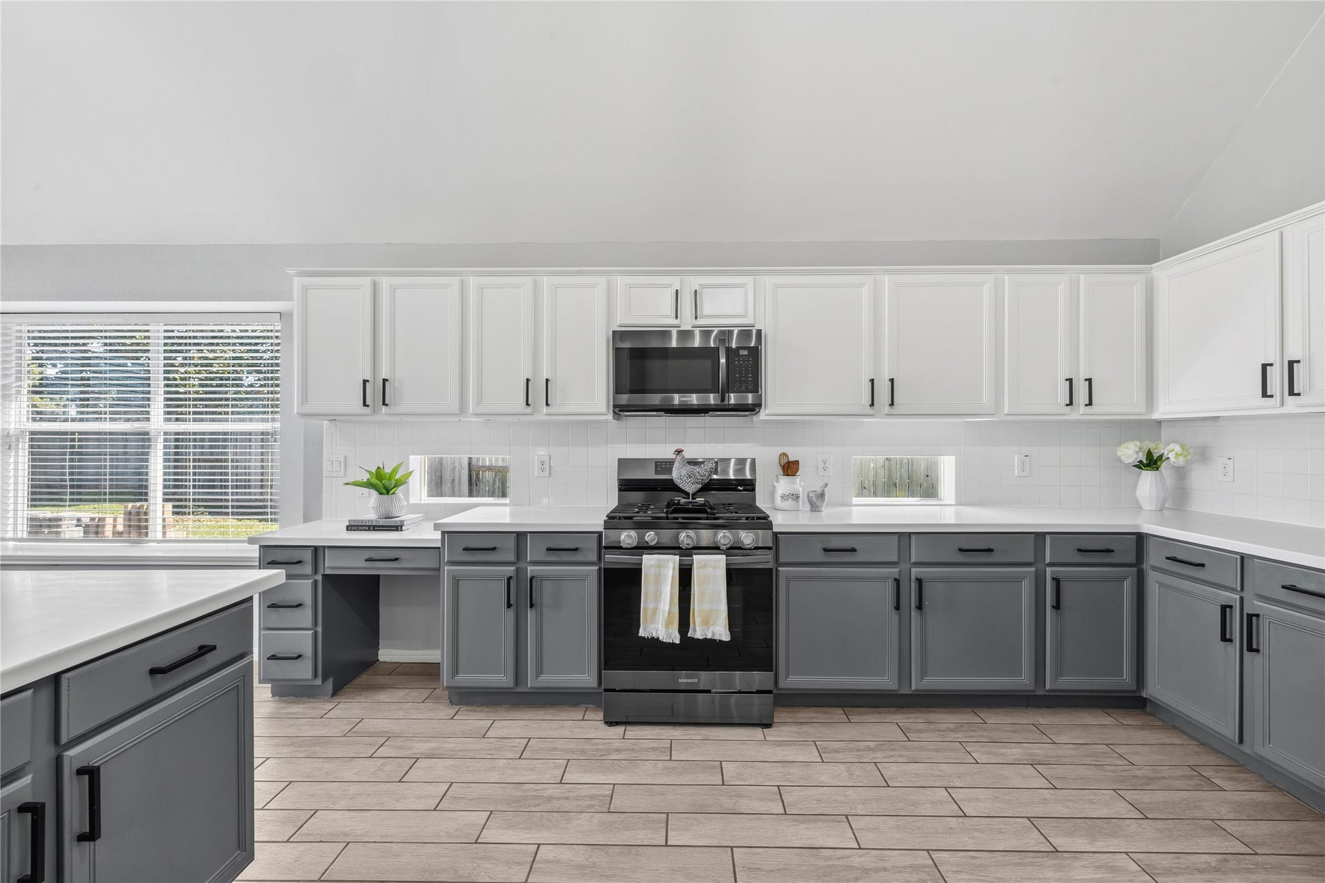 4011 Grayson Court, Missouri City, TX 77459 Spacious kitchen with modern two-tone cabinetry and ample natural light from windows.