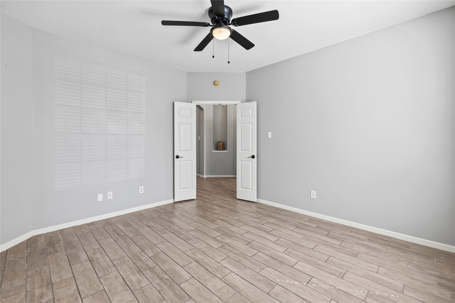 4011 Grayson Court, Missouri City, TX 77459 Spacious room with French doors, flooring and modern ceiling fan, featuring double doors leading to an adjacent area.