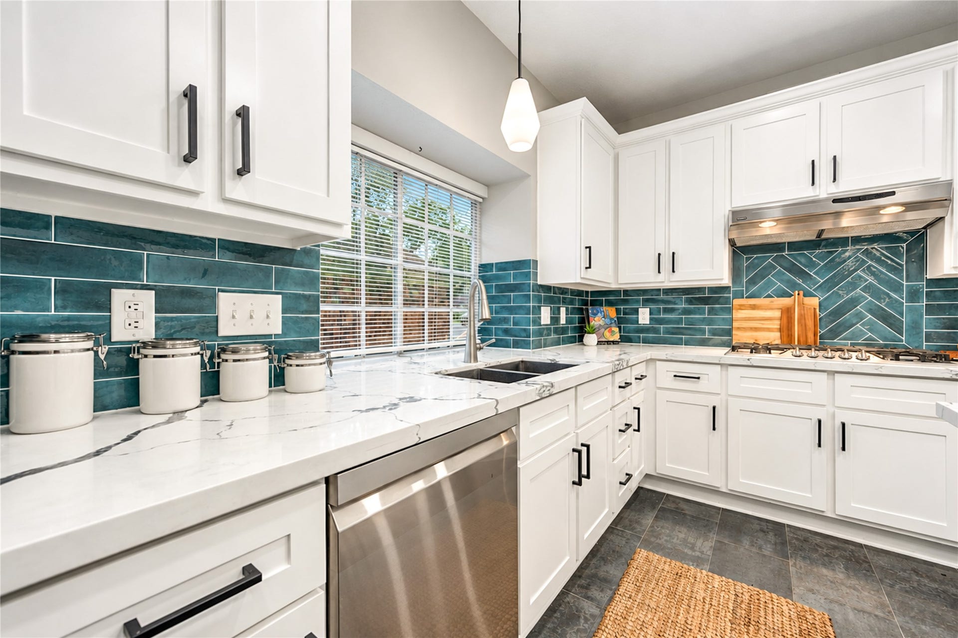 14215 Edinburgh Court, Houston, TX 77077 Cooking becomes a pleasure in this beautifully renovated kitchen! Generous quartz countertops offer plenty of room for meal prep, while stainless steel appliances, crisp white cabinetry and a striking subway tile backsplash bring style and function together. Whether creating a gourmet dinner or preparing a quick family favorite, everything you need is right at your fingertips!