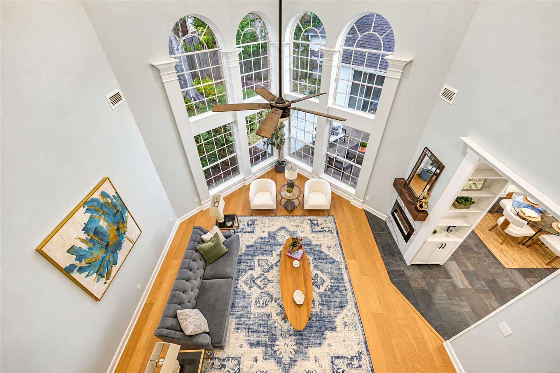 14215 Edinburgh Court, Houston, TX 77077 Soaring ceilings, dramatic two-story windows and an abundance of natural light create a breathtaking living space! Whether hosting memorable gatherings or enjoying a quiet evening at home, this impressive room offers an inviting atmosphere for making lasting memories.