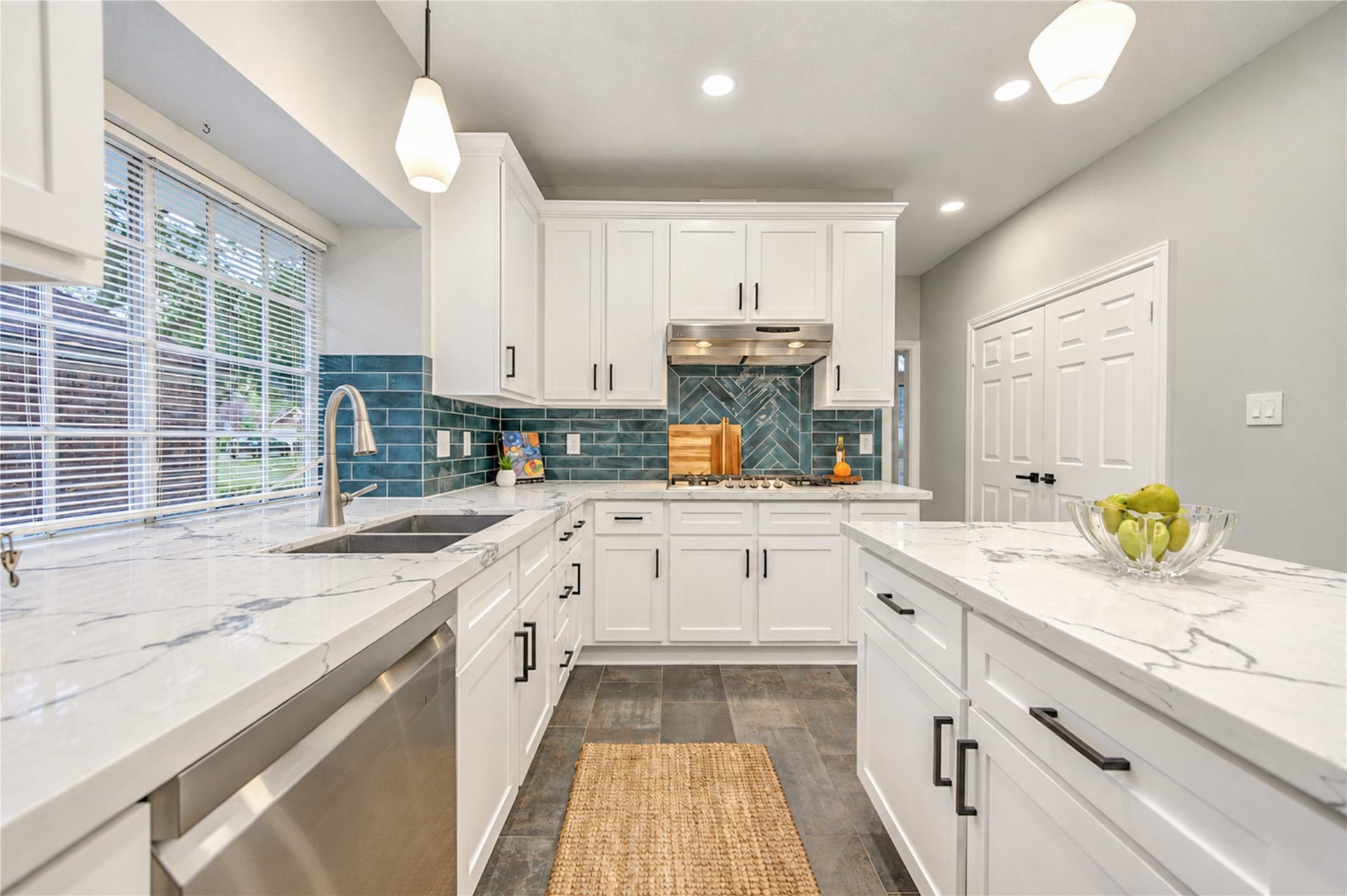 14215 Edinburgh Court, Houston, TX 77077 The heart of the home! This beautifully renovated kitchen brings everyone together with gleaming quartz countertops, crisp white cabinetry, stainless steel appliances and a stylish subway tile backsplash. Whether preparing a quiet morning breakfast or hosting friends and family, this inviting space makes every gathering feel special.