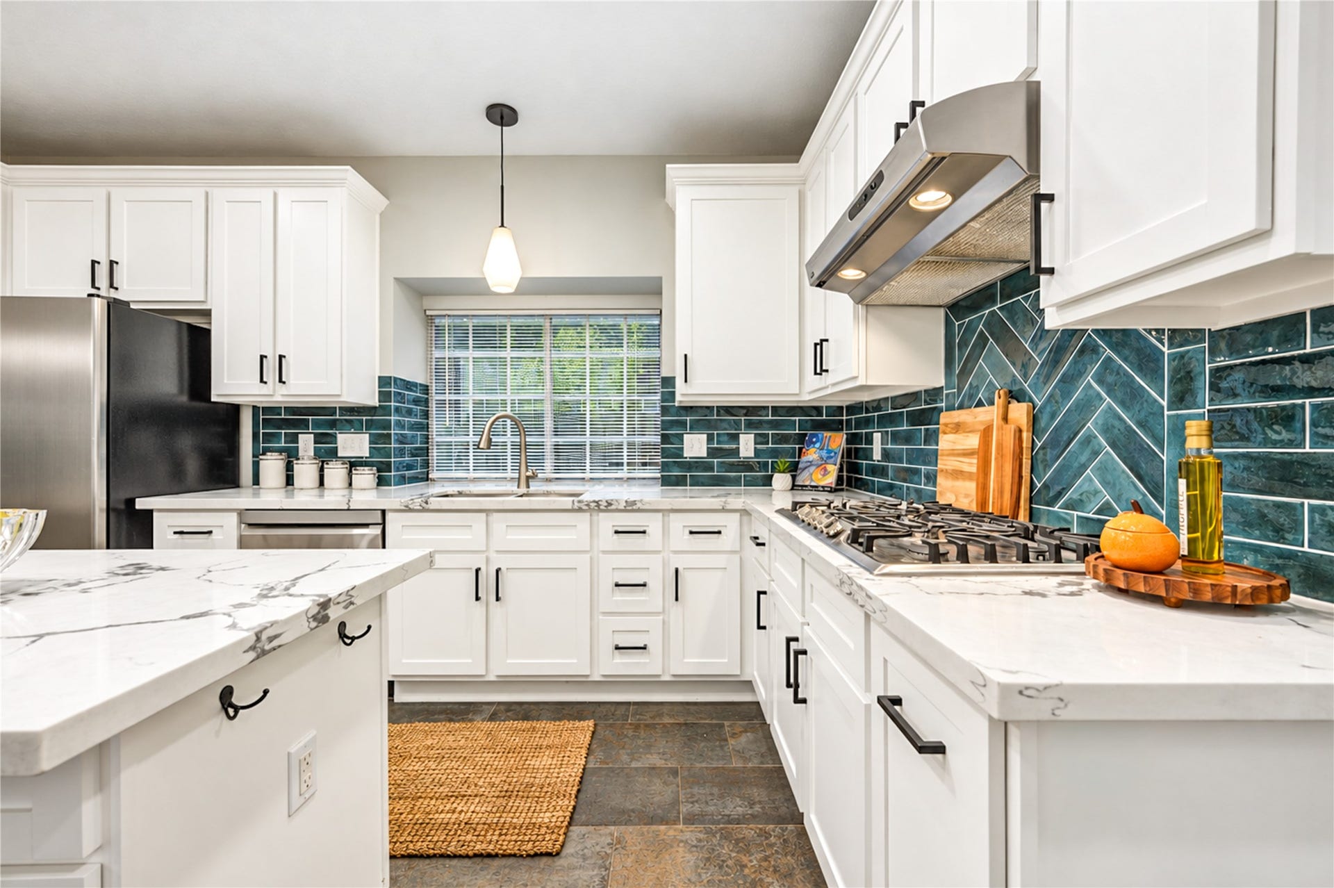14215 Edinburgh Court, Houston, TX 77077 From quick morning coffees to preparing your favorite meals, this beautifully updated kitchen makes every moment a pleasure! Crisp white cabinetry, gleaming quartz countertops, stainless steel appliances and a stylish subway tile backsplash create a fresh, timeless space where cooking, conversation and everyday living come together effortlessly.
