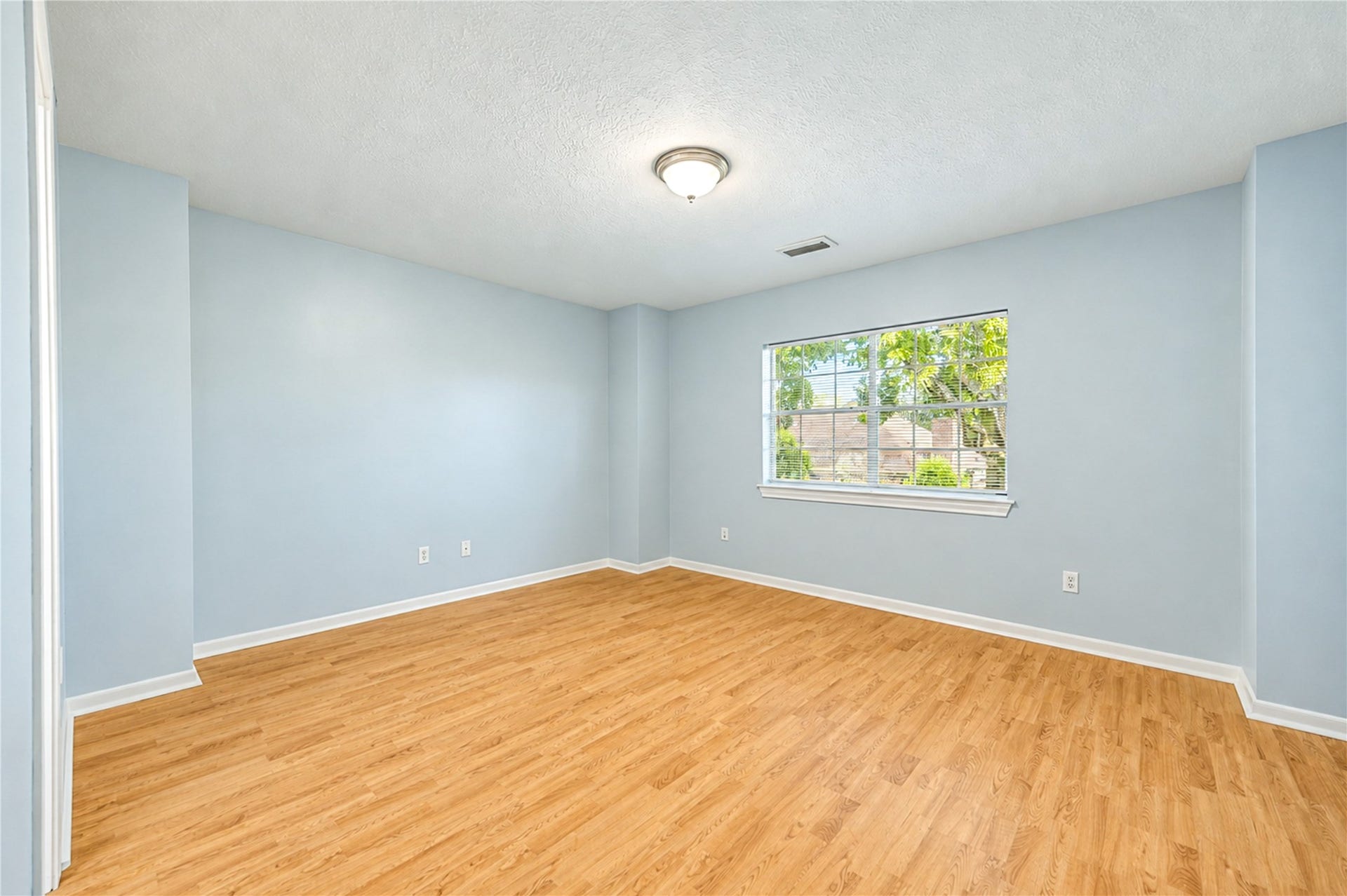 14215 Edinburgh Court, Houston, TX 77077 Bright, spacious and full of possibilities! This second upstairs bedroom features beautiful wood flooring, soft neutral tones and natural light, creating a welcoming space to relax and recharge. With plenty of room to personalize, it's ready to become a comfortable retreat that reflects your style!