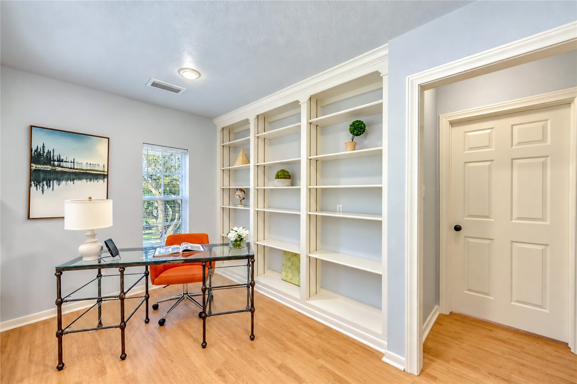 14215 Edinburgh Court, Houston, TX 77077 Your ideal work-from-home retreat awaits! This bright second-floor study features beautiful built-in shelving, warm wood floors and plenty of natural light, creating an inspiring space to work, read or pursue your passions. A peaceful escape designed for productivity and creativity!