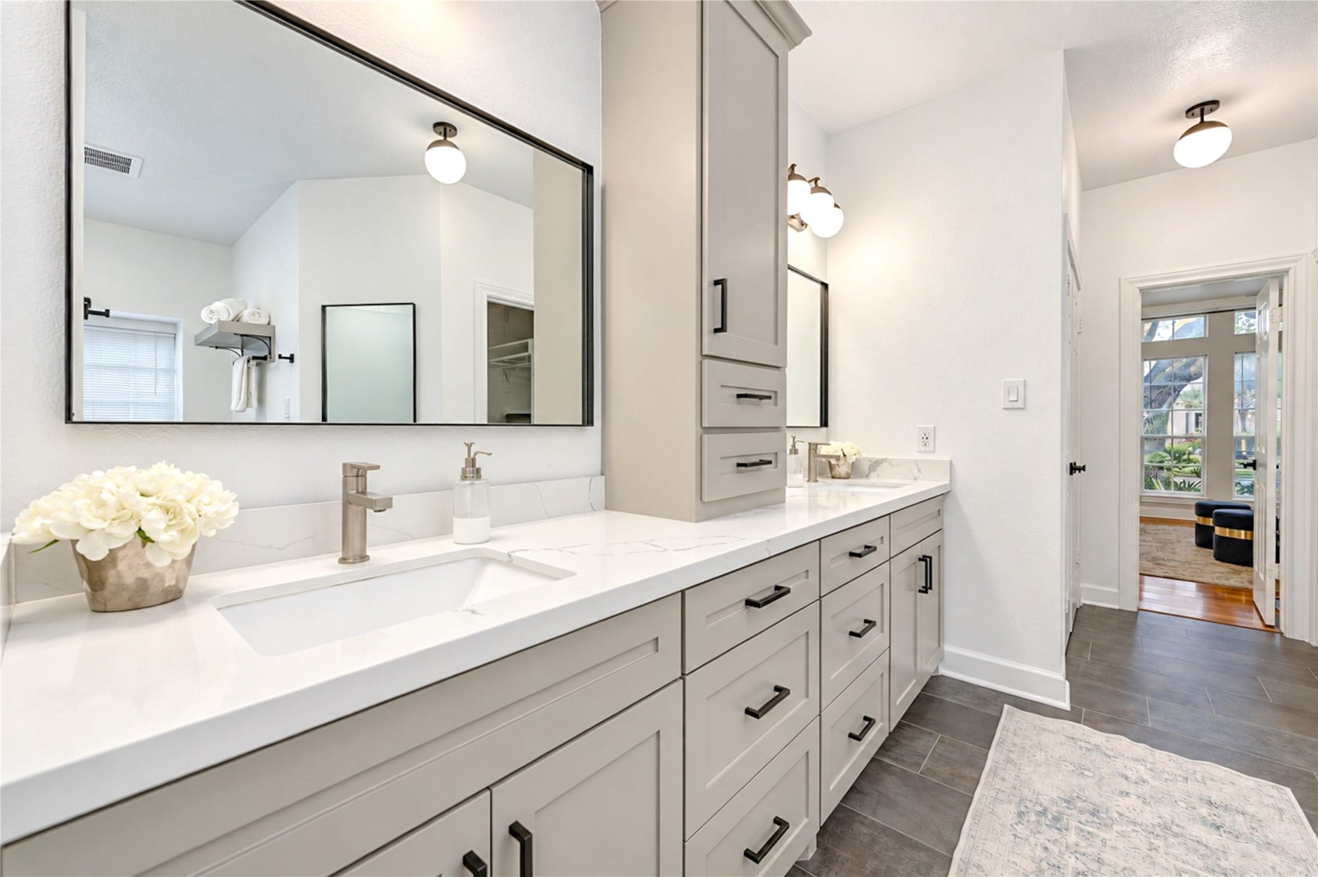 14215 Edinburgh Court, Houston, TX 77077 Indulge in a little everyday luxury in this beautifully renovated primary ensuite bath! Elegant quartz countertops, dual vanities and stylish modern finishes create a spa-inspired atmosphere, while the spacious layout makes morning routines effortless and evenings feel like a relaxing retreat.